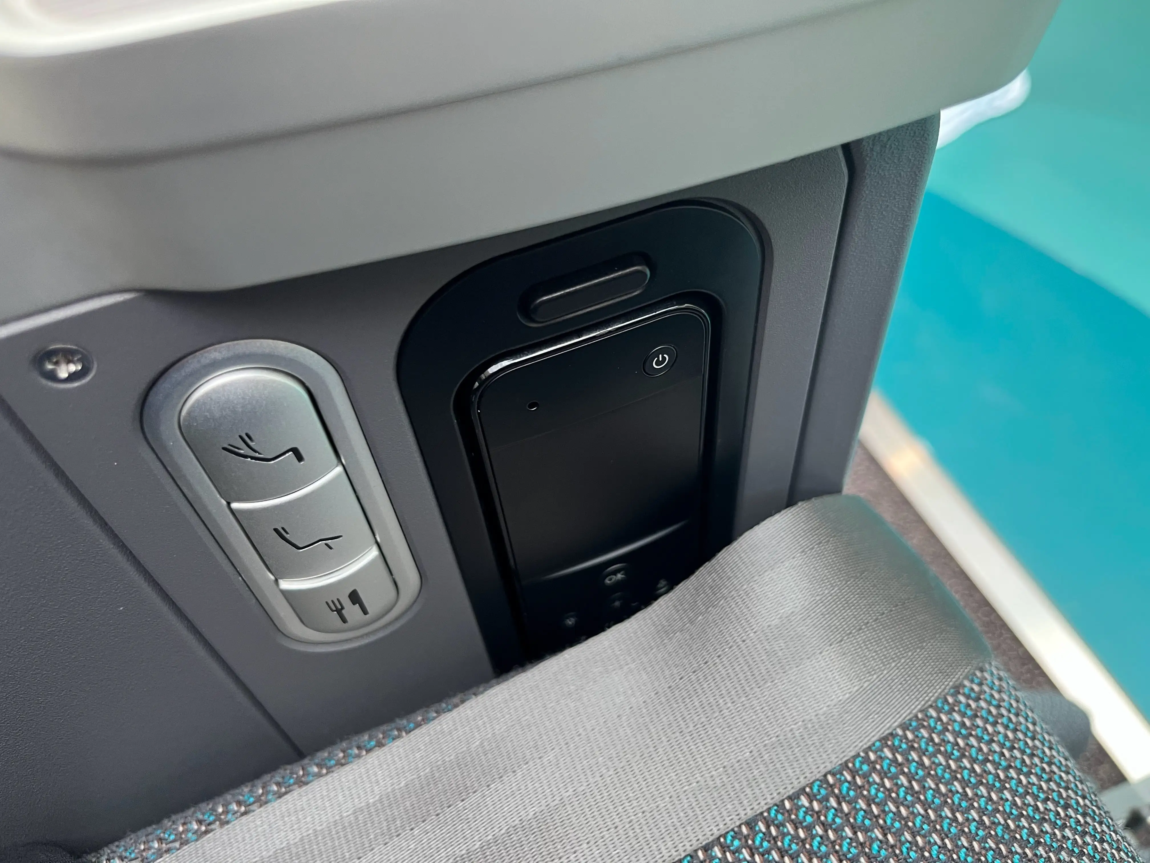 Call buttons and a remote in premium economy on Cathay Pacific.