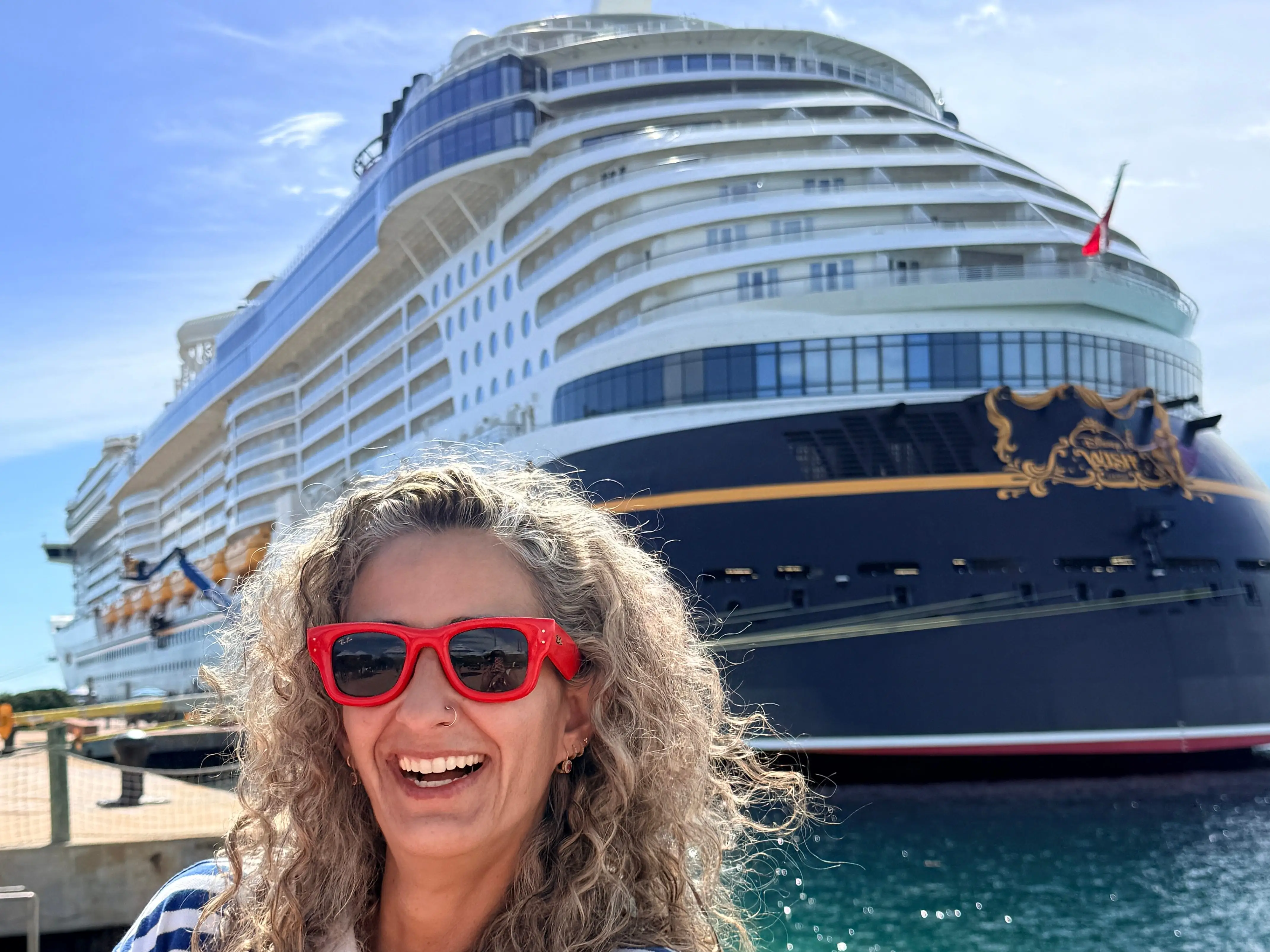 Woman posting with cruise ship