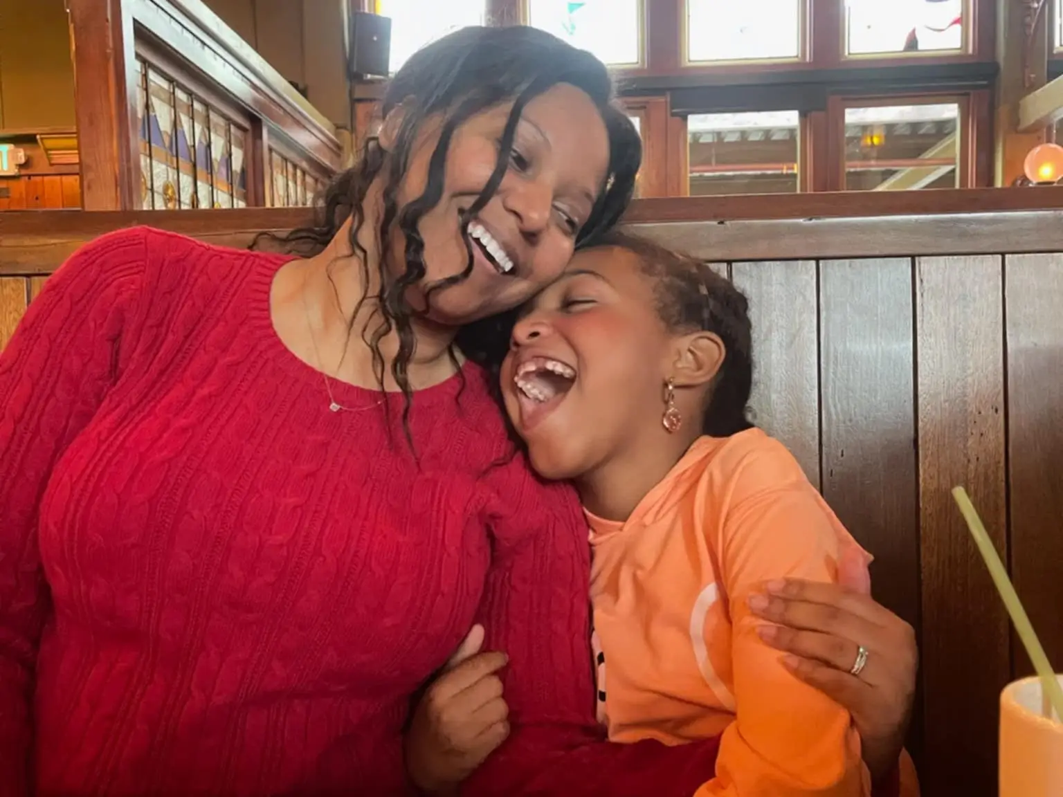 Mom and daughter laughing.