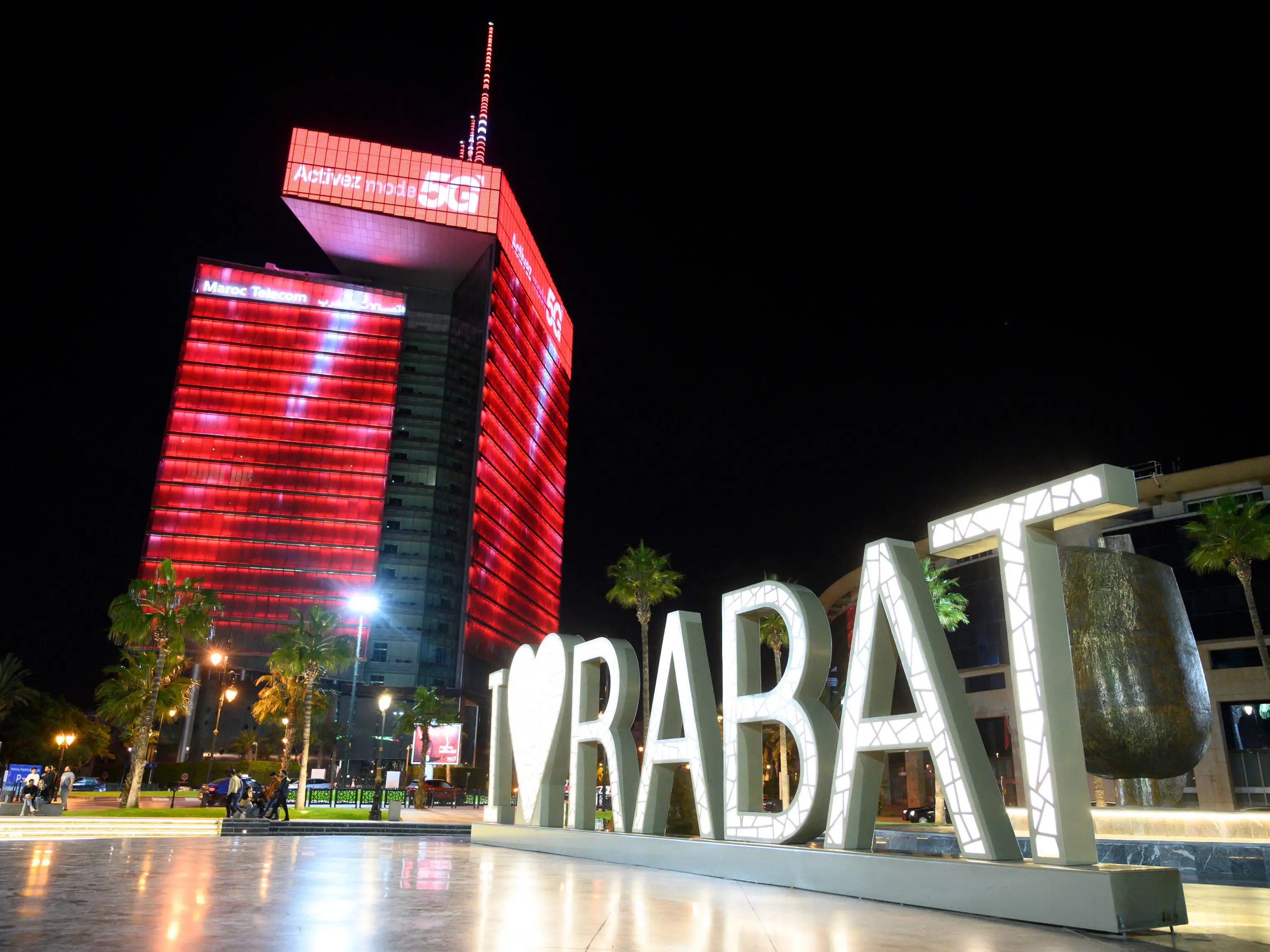 The Maroc Telecom Tower is illuminated in red as part of the city's modern nighttime skyline