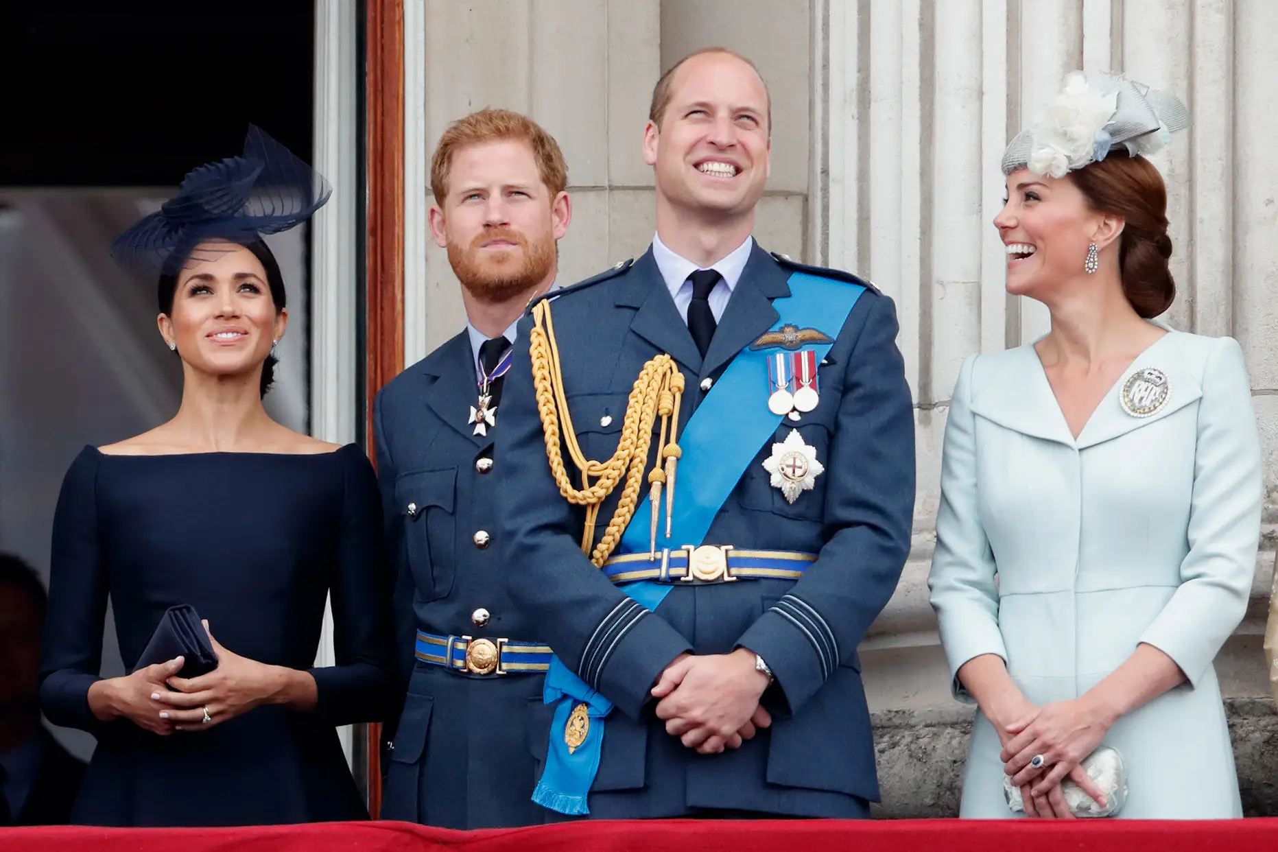 Meghan Markle, Prince Harry, Prince William and Catherine stand on a palace balcony during a formal royal event.