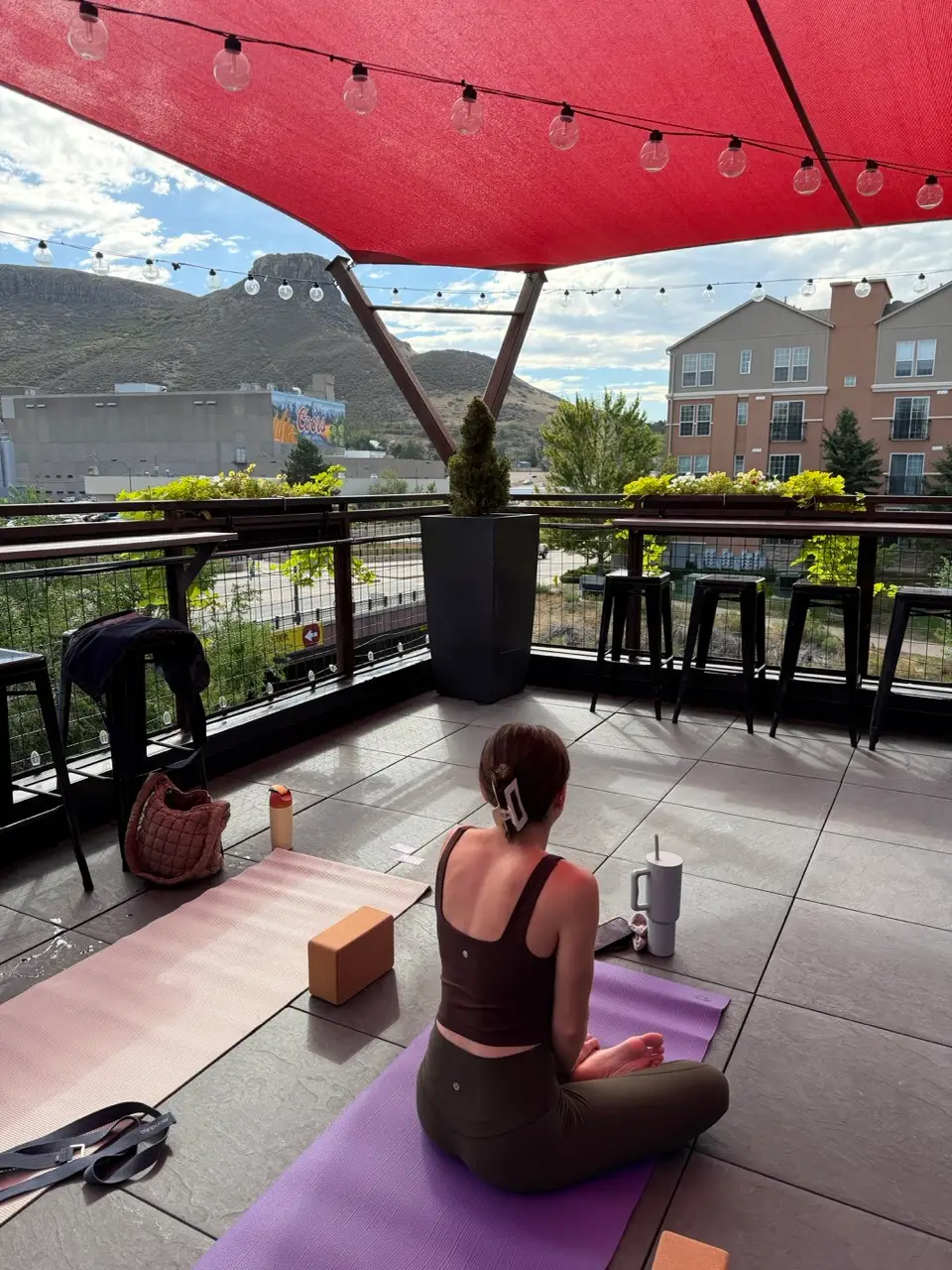 Woman in mostly empty area on yoga mat