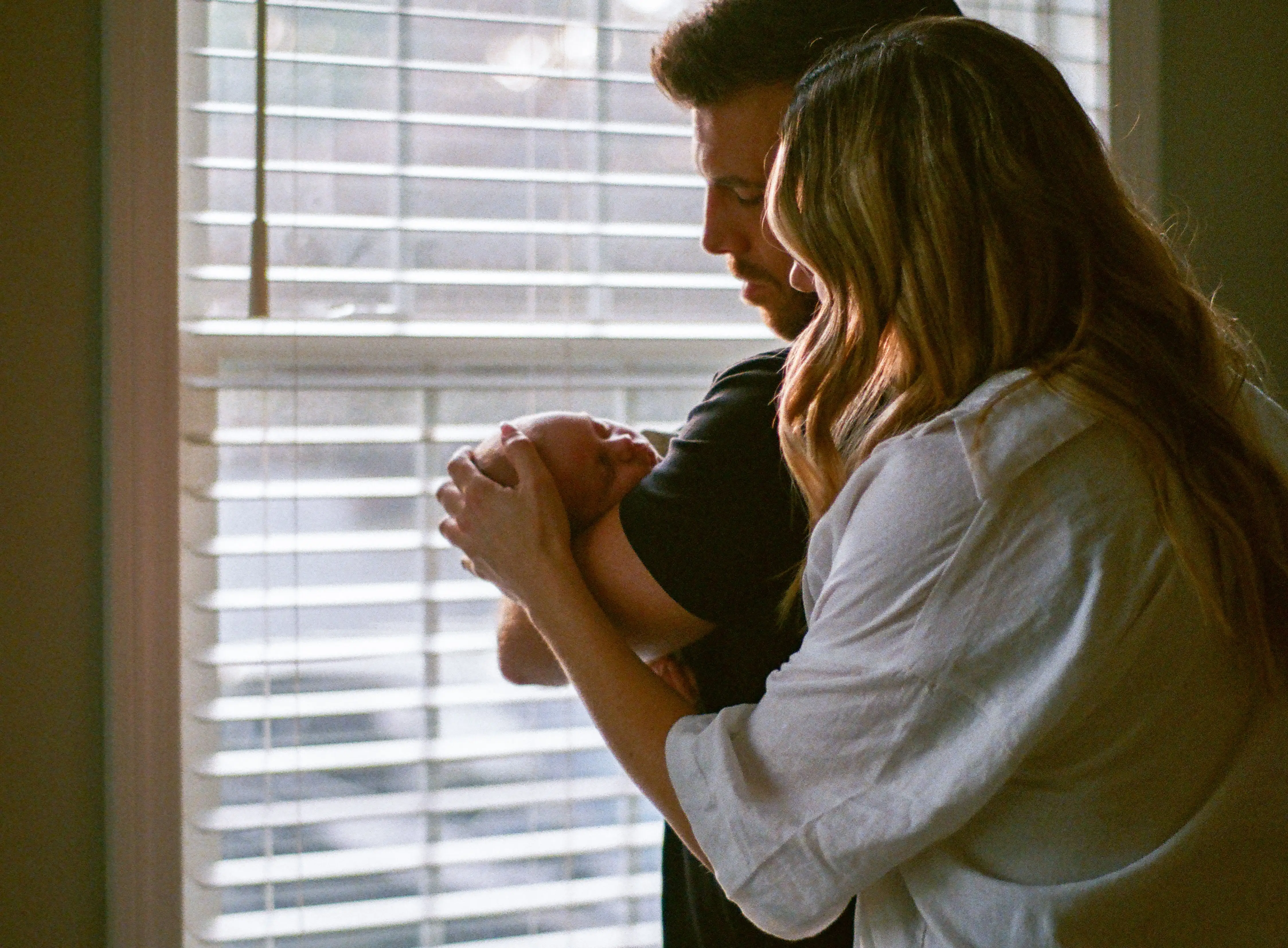 the author with her son and husband by a window
