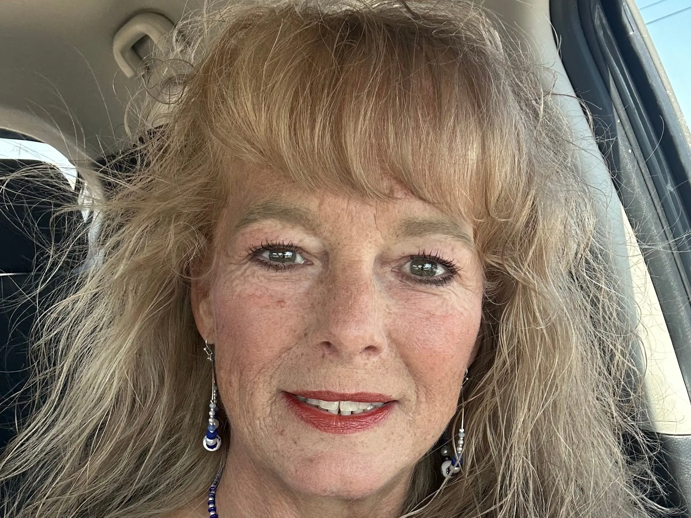 A selfie of a woman in a car