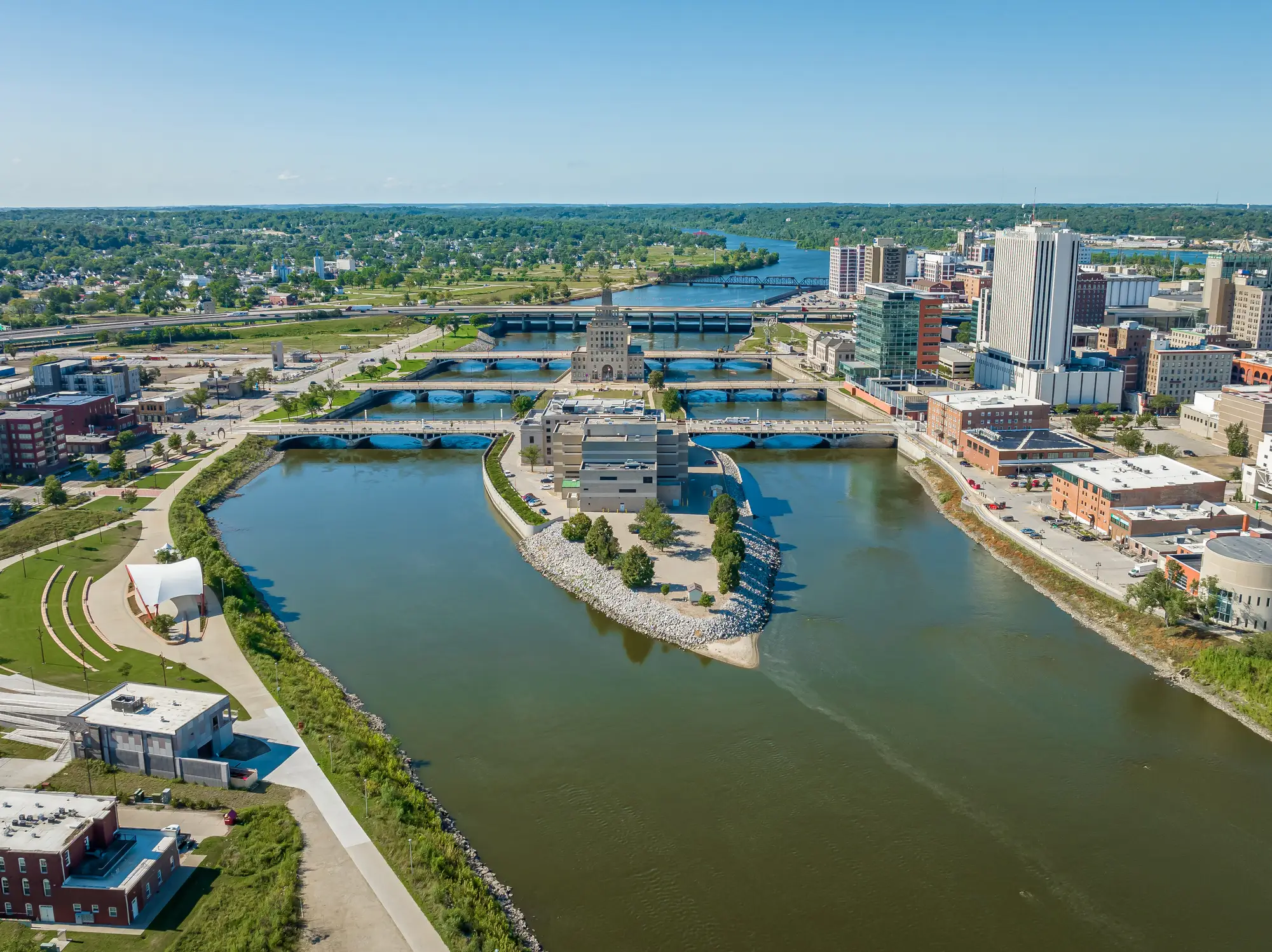 Aerial view of downtown Cedar Rapids along the Cedar River with bridges, Mays Island, and skyline buildings.