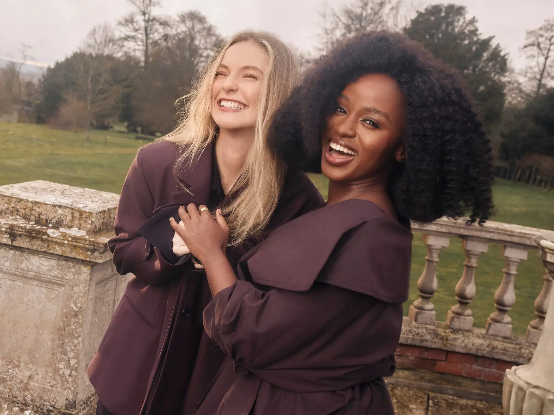 Hannah Dodd and Masali Baduza hugging and laughing for season five 'Bridgerton' press