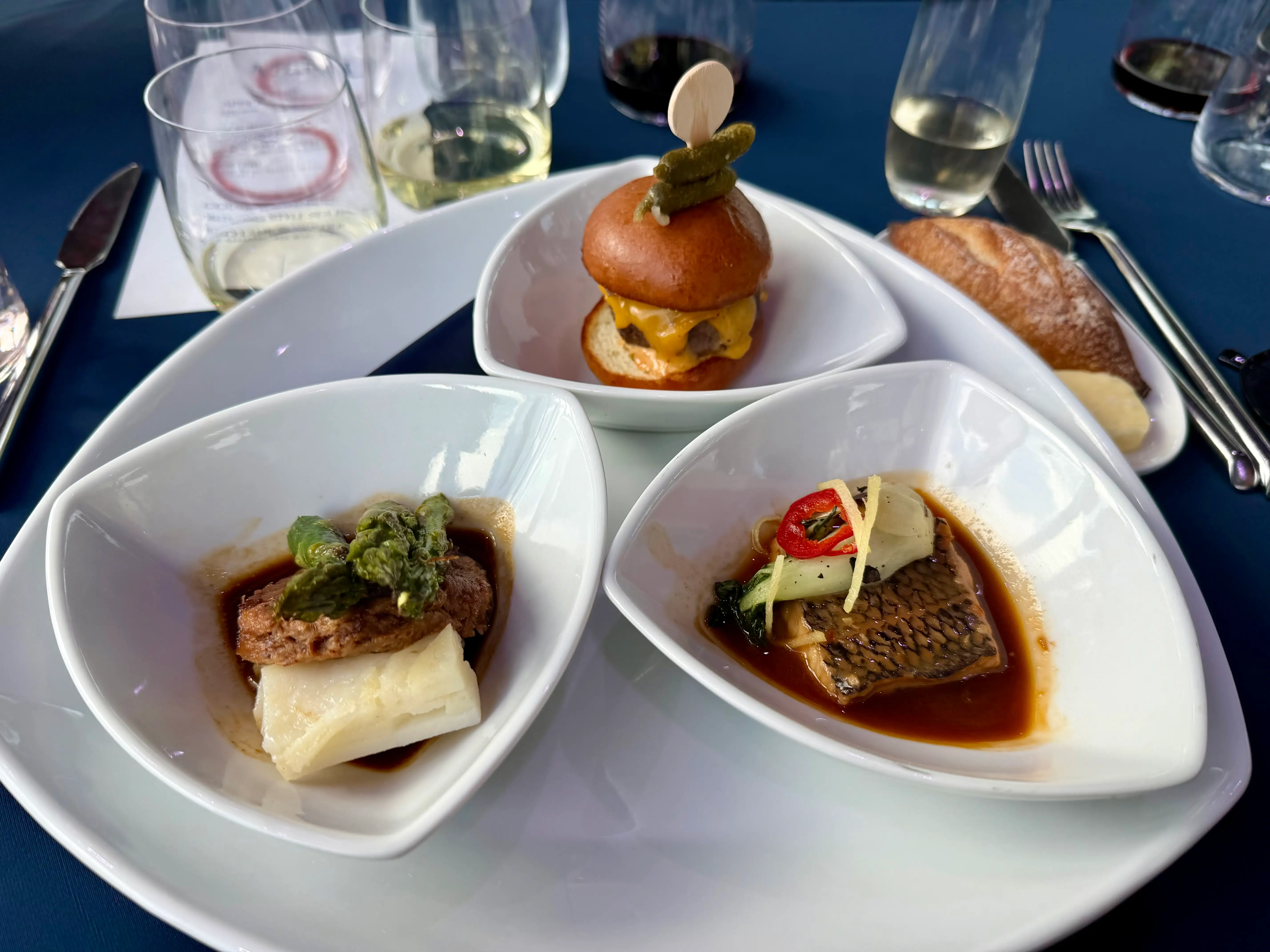 Some examples of the food: wagyu slider, sea bass, and lamb plated.