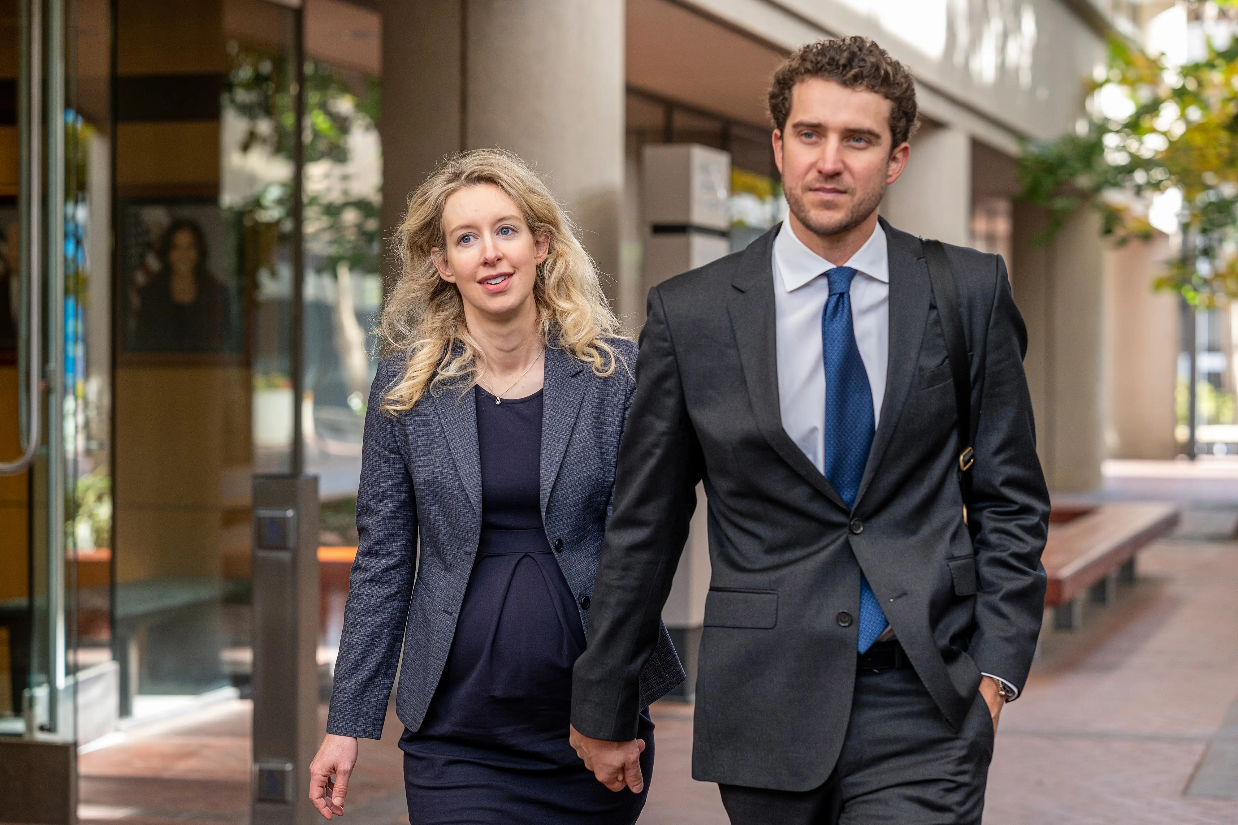 Elizabeth Holmes and Billy Evans leave federal court in San Jose, California, in 2022.