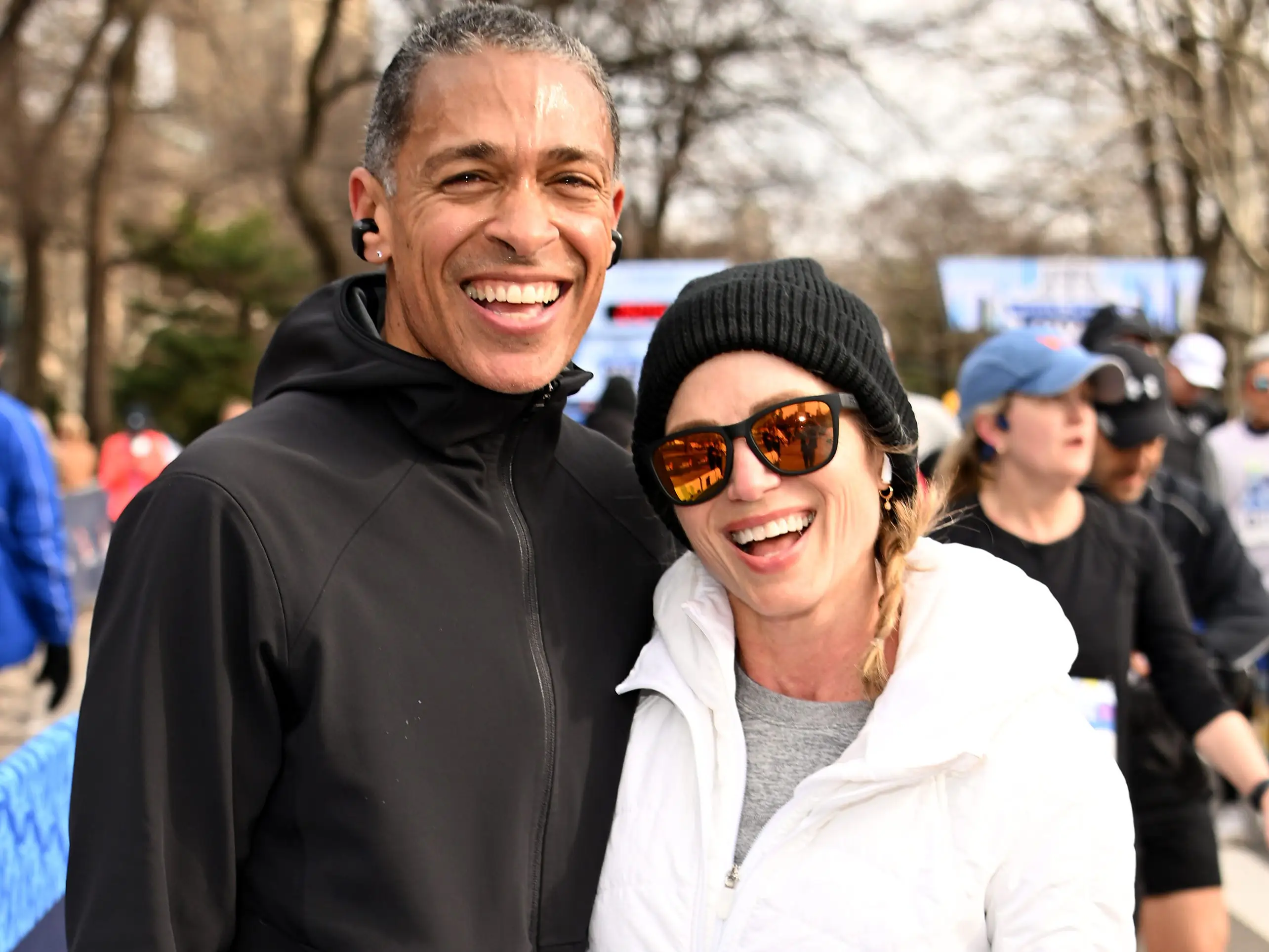 TJ Holmes and Amy Robach pose after crossing the finish line during the 2026 United Airlines NYC Half Marathon in Central Park on March 15, 2026 in New York City.