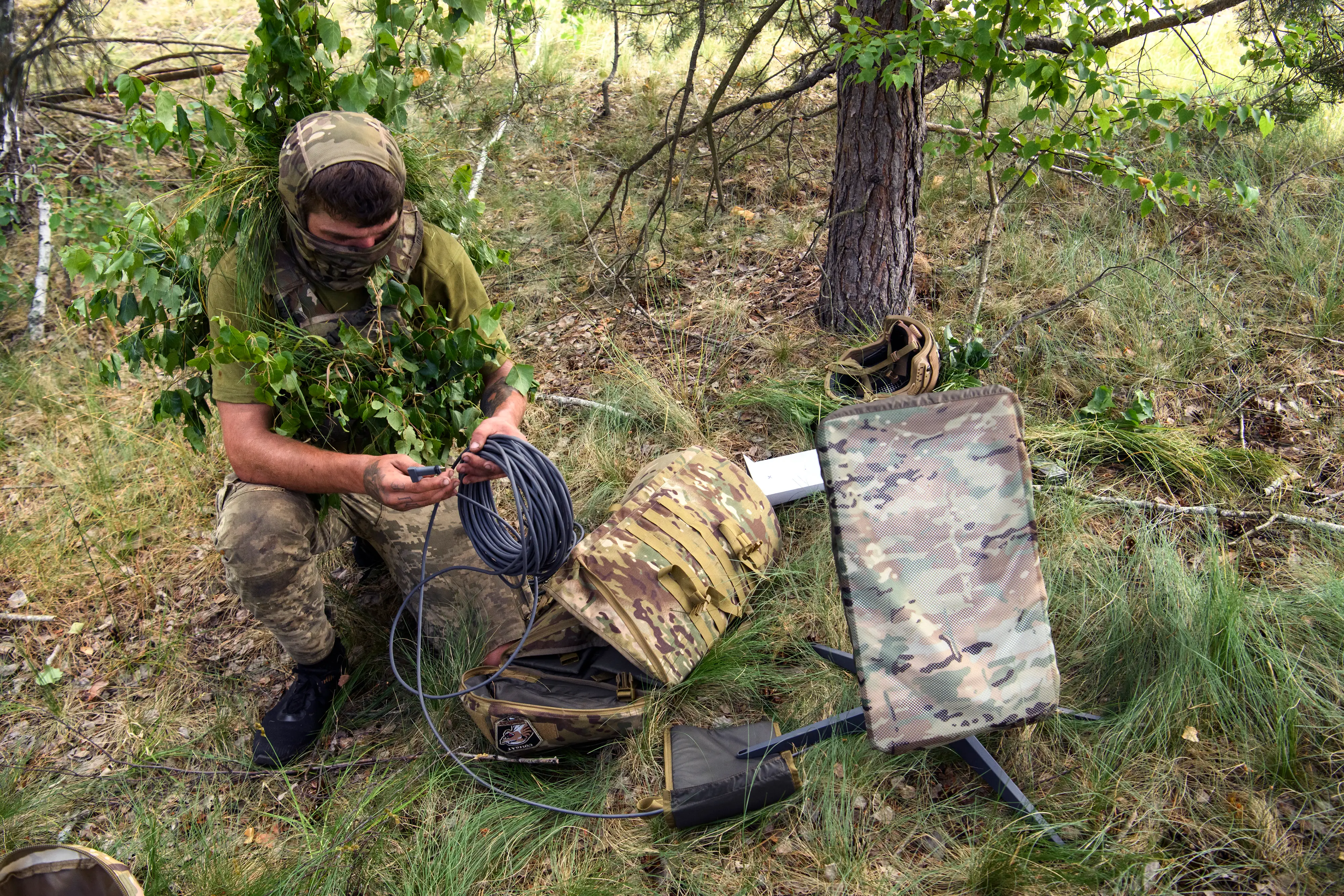A Ukrainian soldier of the 61st Separate Mechanized Brigade uses the Starlink system during military exercises.