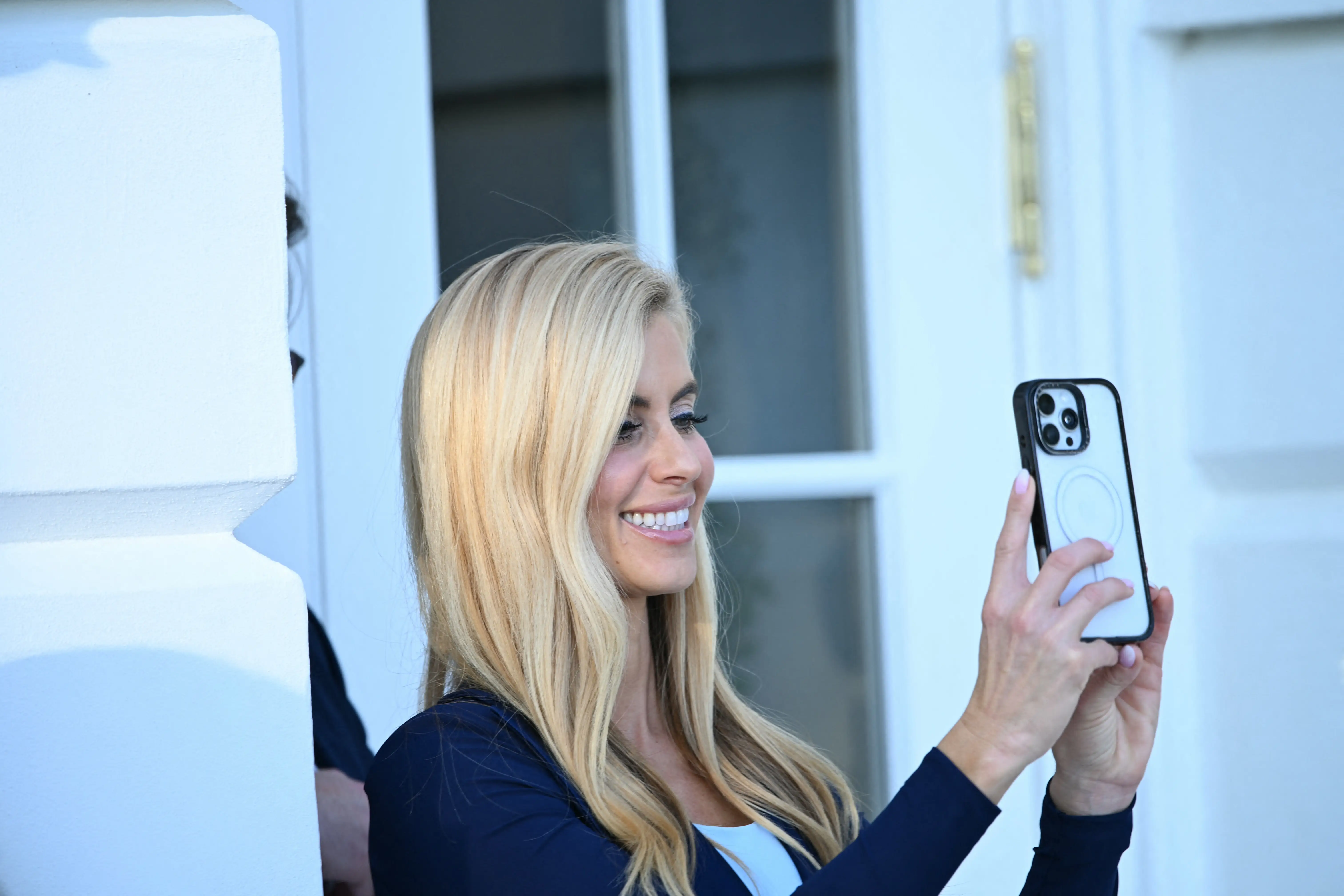 Katie Zacharia holds up her phone.