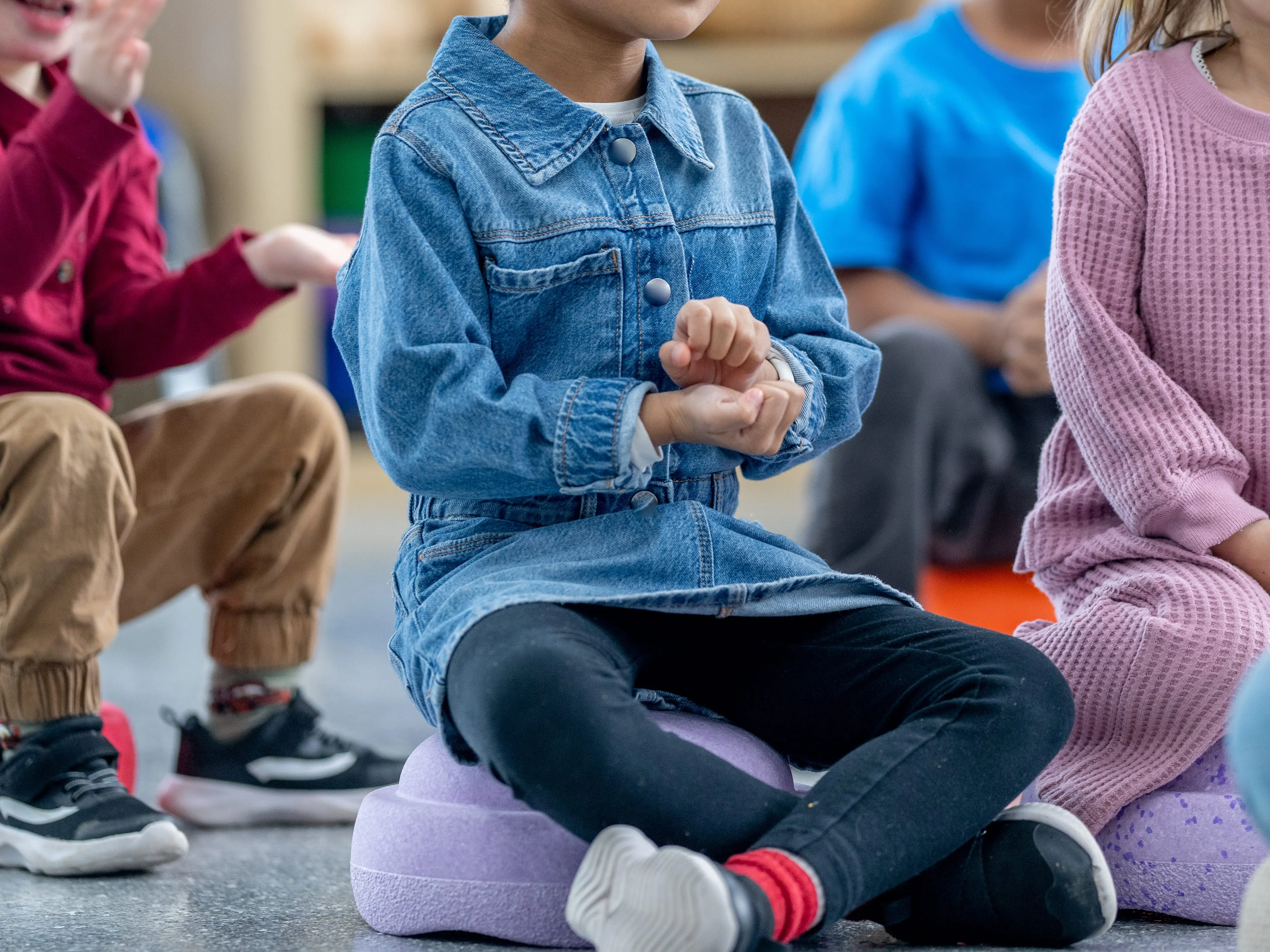 Children sitting on rug