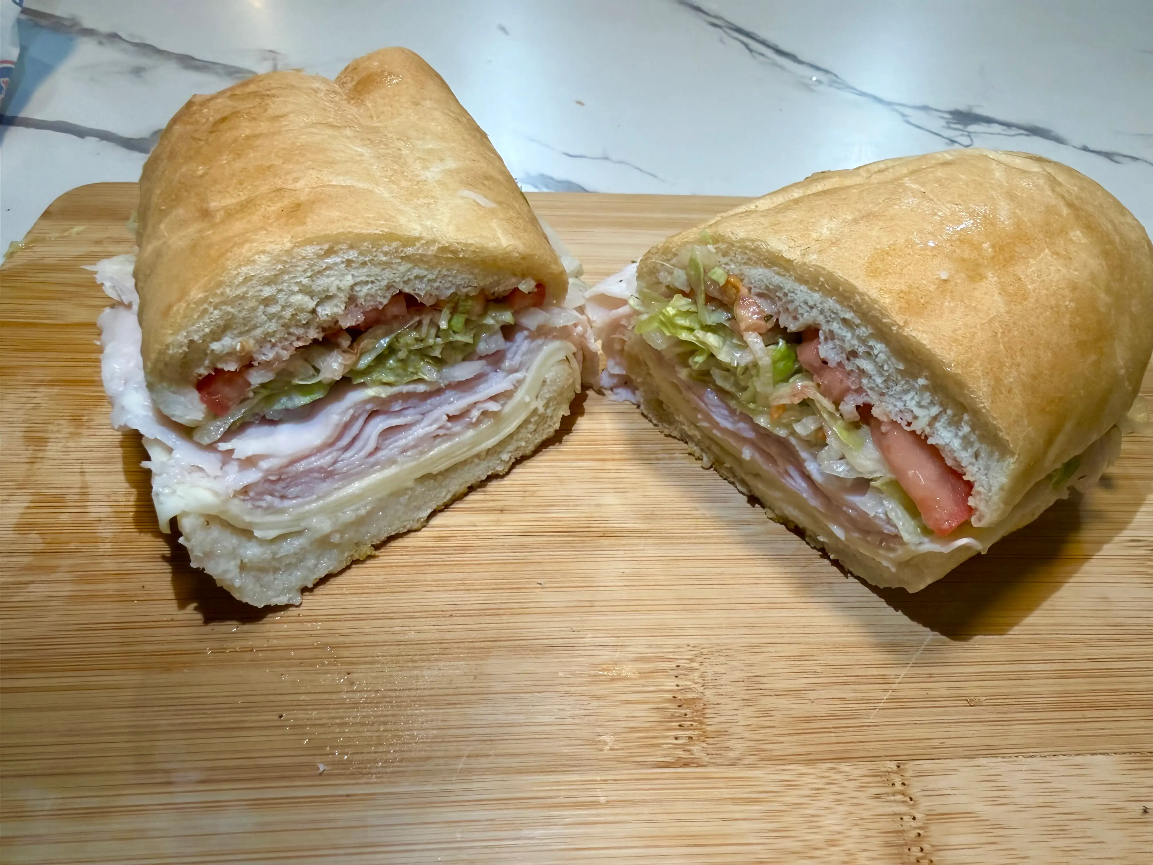 Jersey mike's sandwich cut in half with turkey, lettuce, tomato