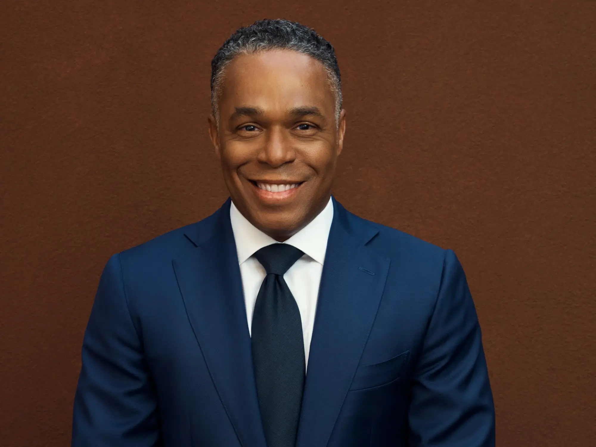 Man wearing a suit and tie smiling