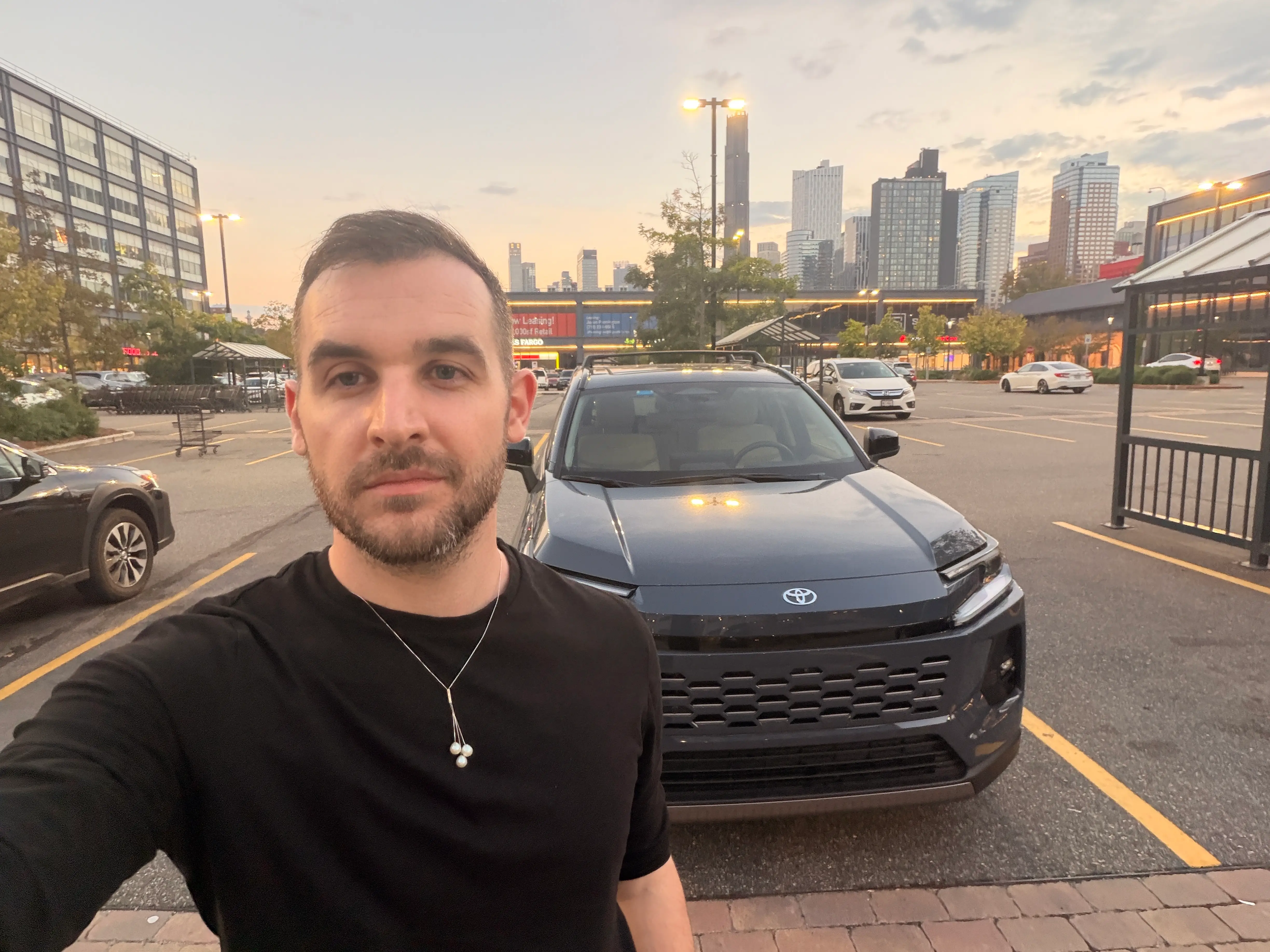 Business Insider's automotive reporter, Ben Shimkus, is standing in front of a 2026 Toyota RAV4.