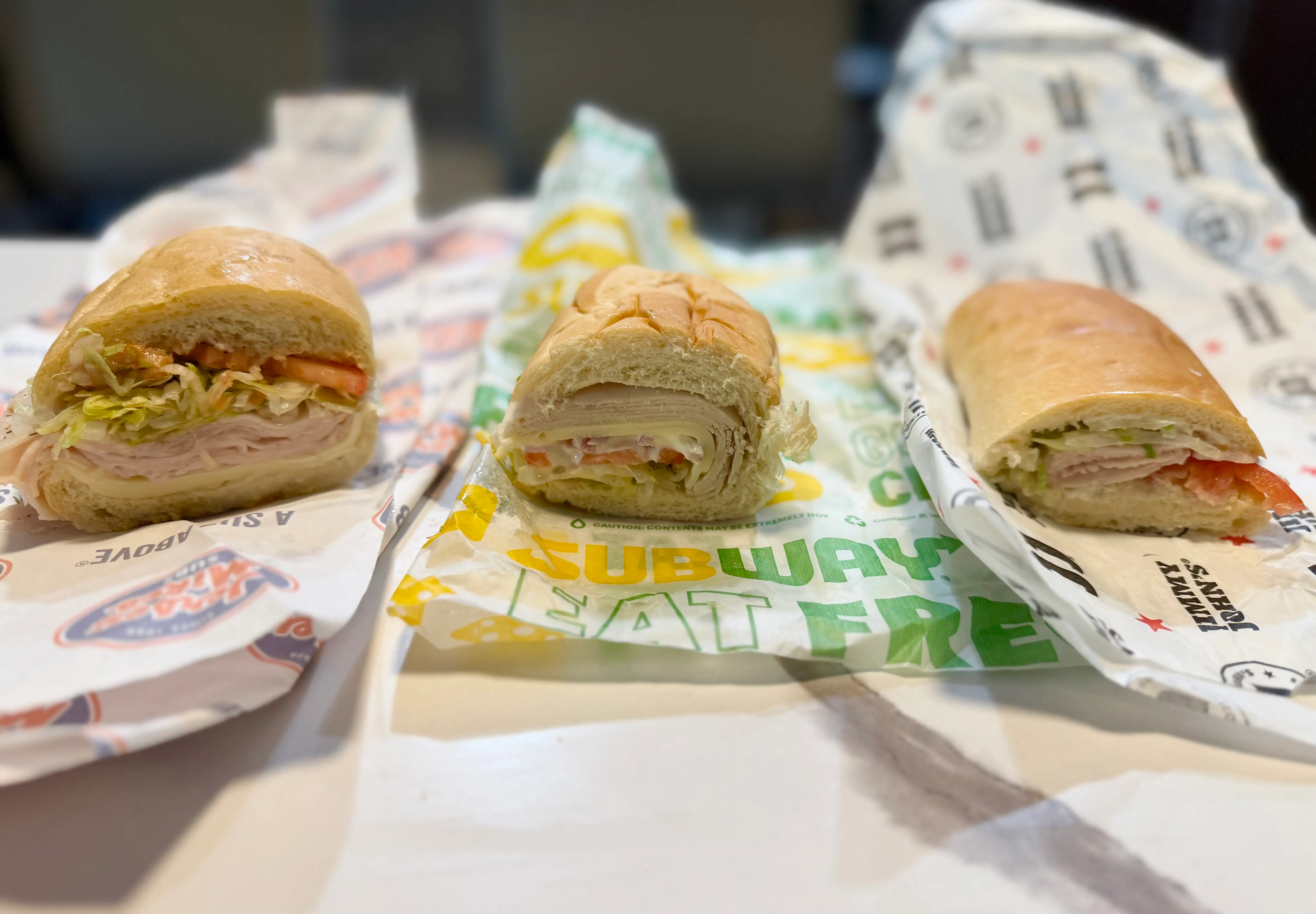 Turkey sandwiches from Jersey Mike's, Subway, and Jimmy Johns on paper wrappers