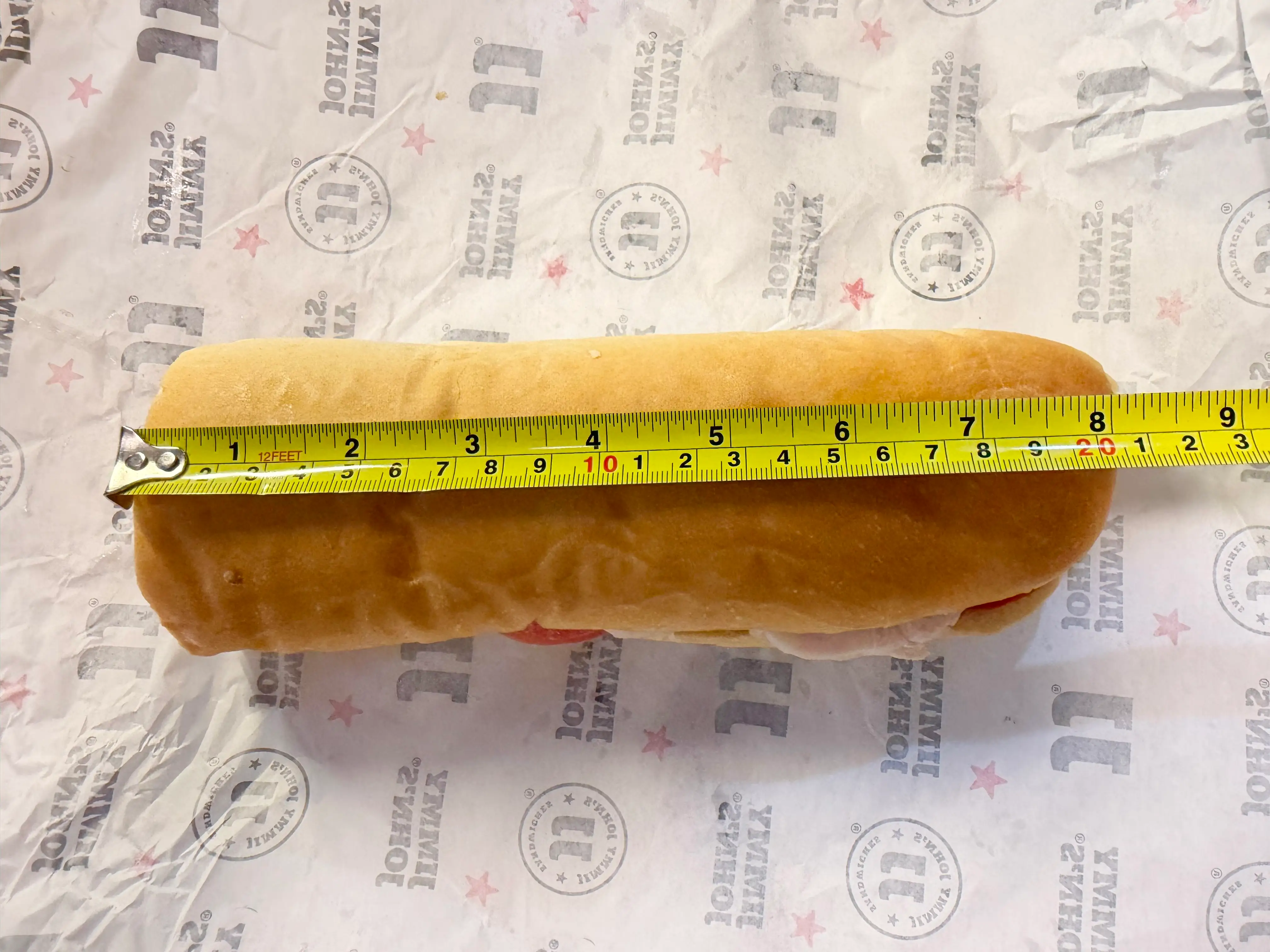 Jimmy John's sandwich with measuring tape above it showing 8 inches
