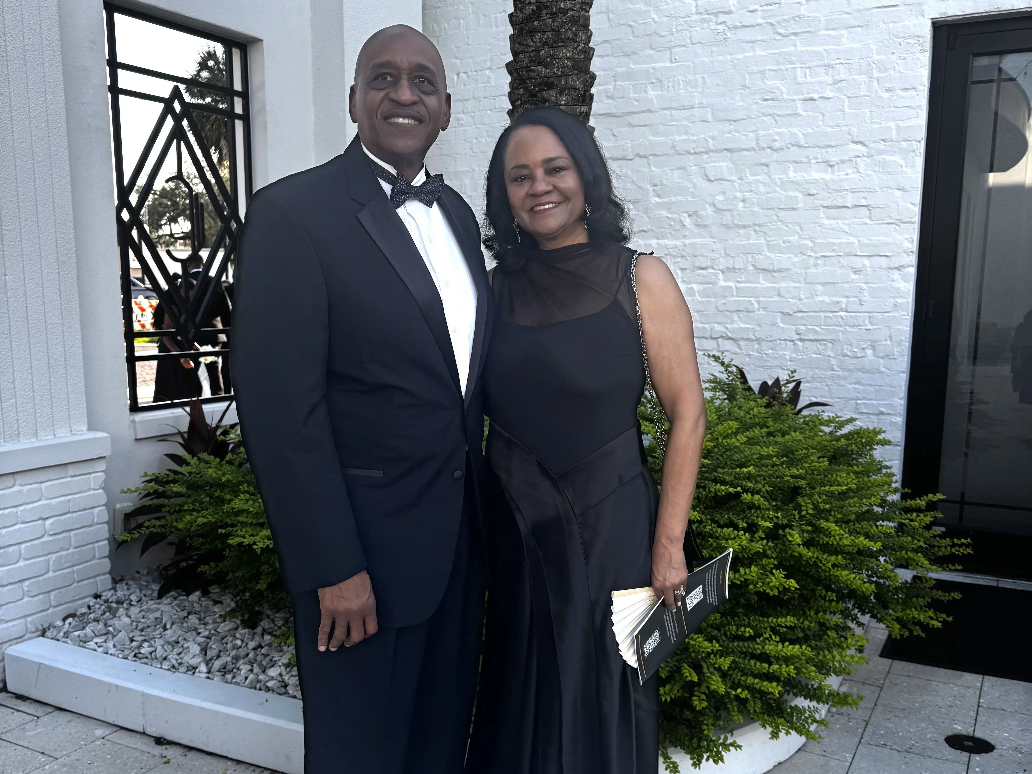 A couple wearing formal evening dress.
