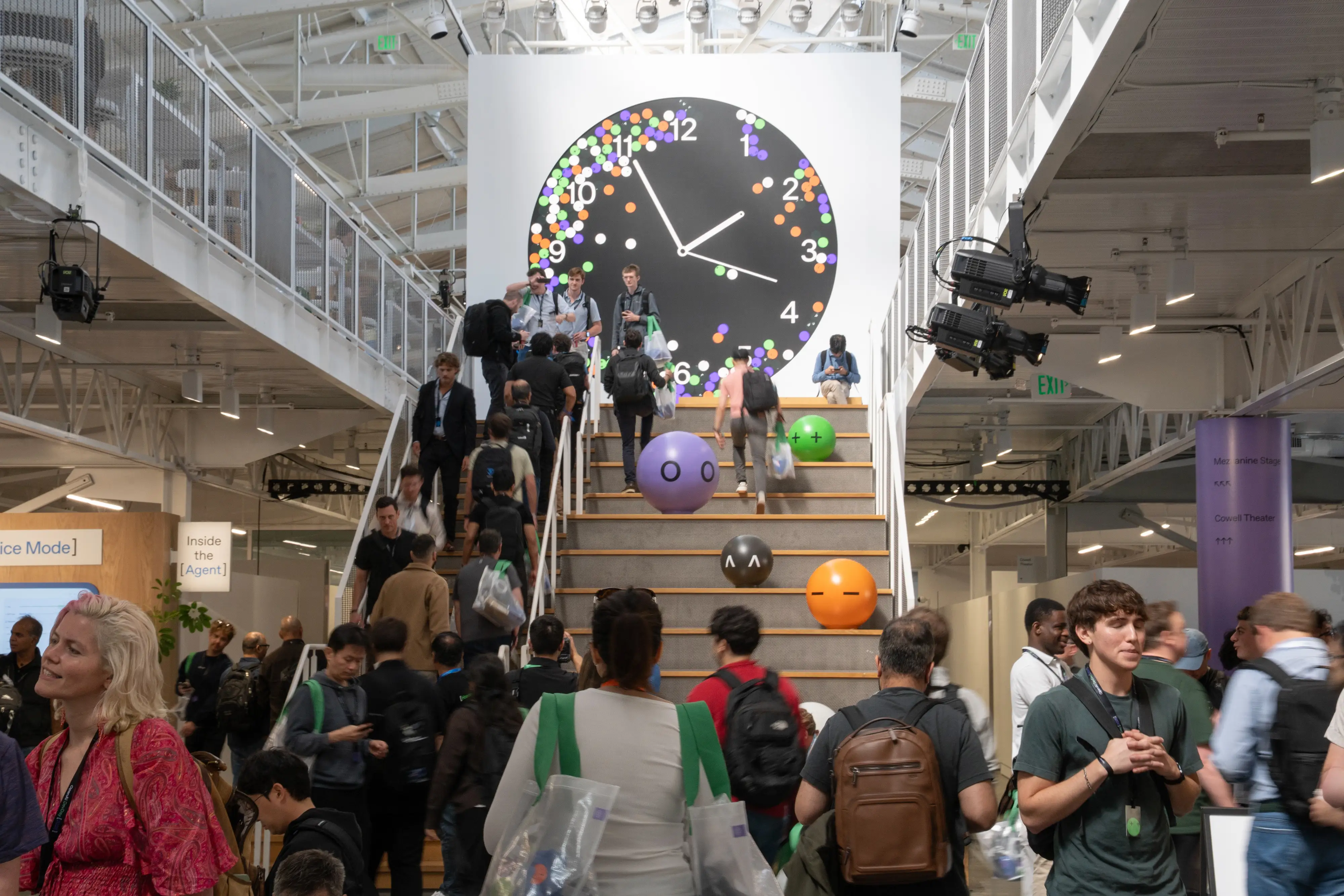 Attendees go up and down stairs at OpenAI's DevDay conference on Sept. 29, 2026.