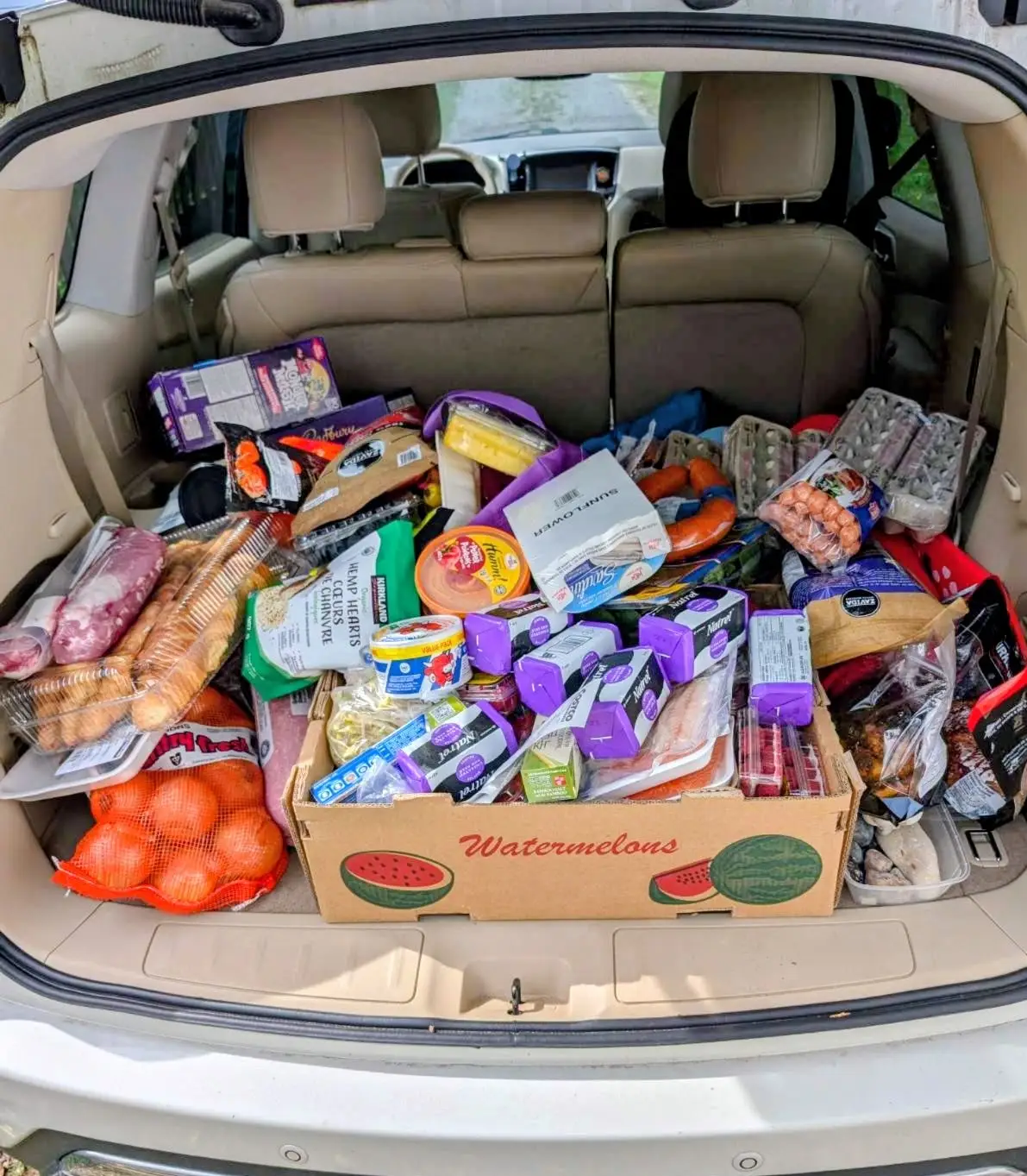 Groceries loaded into trunk of car