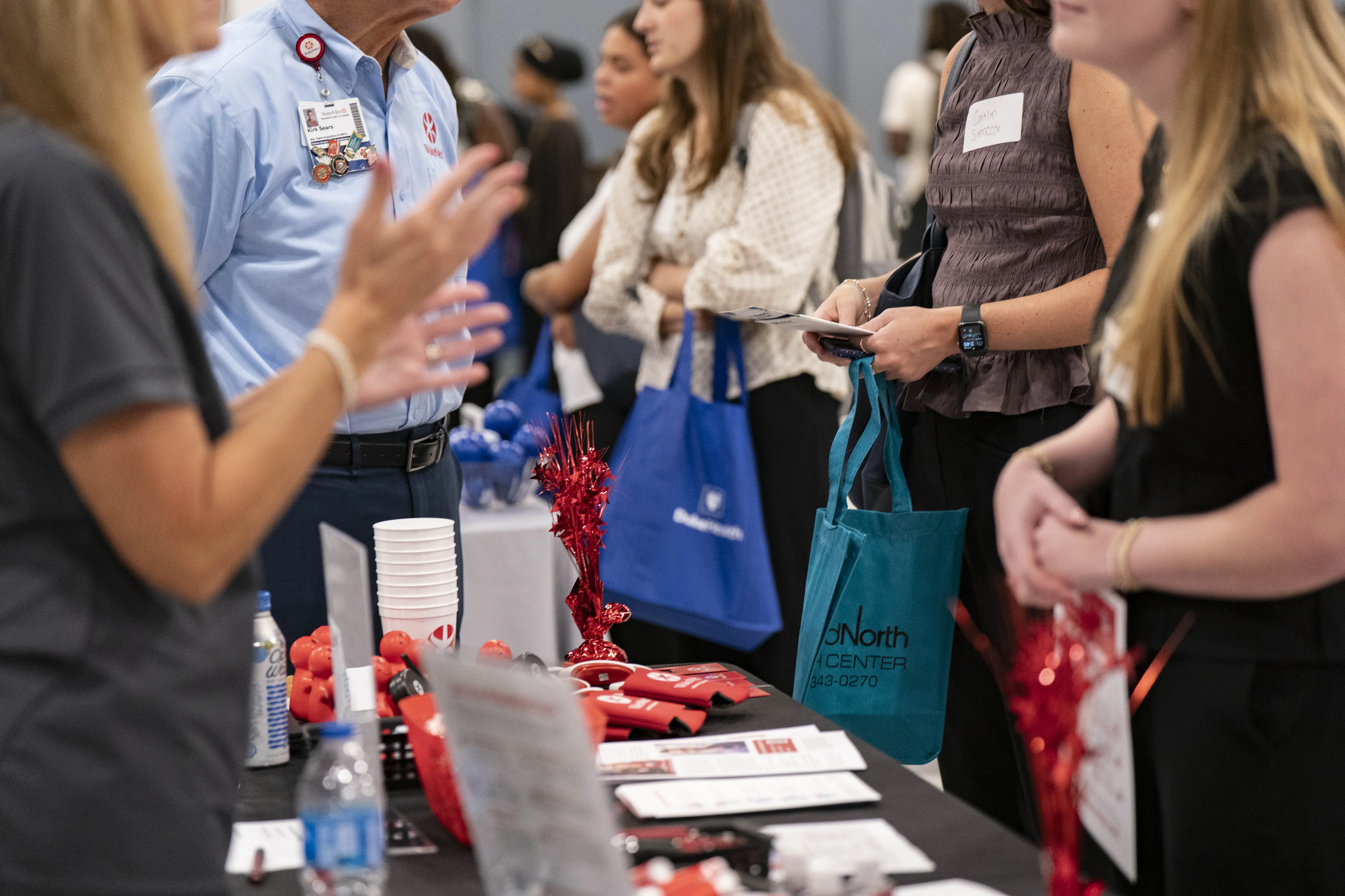 People stand in line at a job fair.