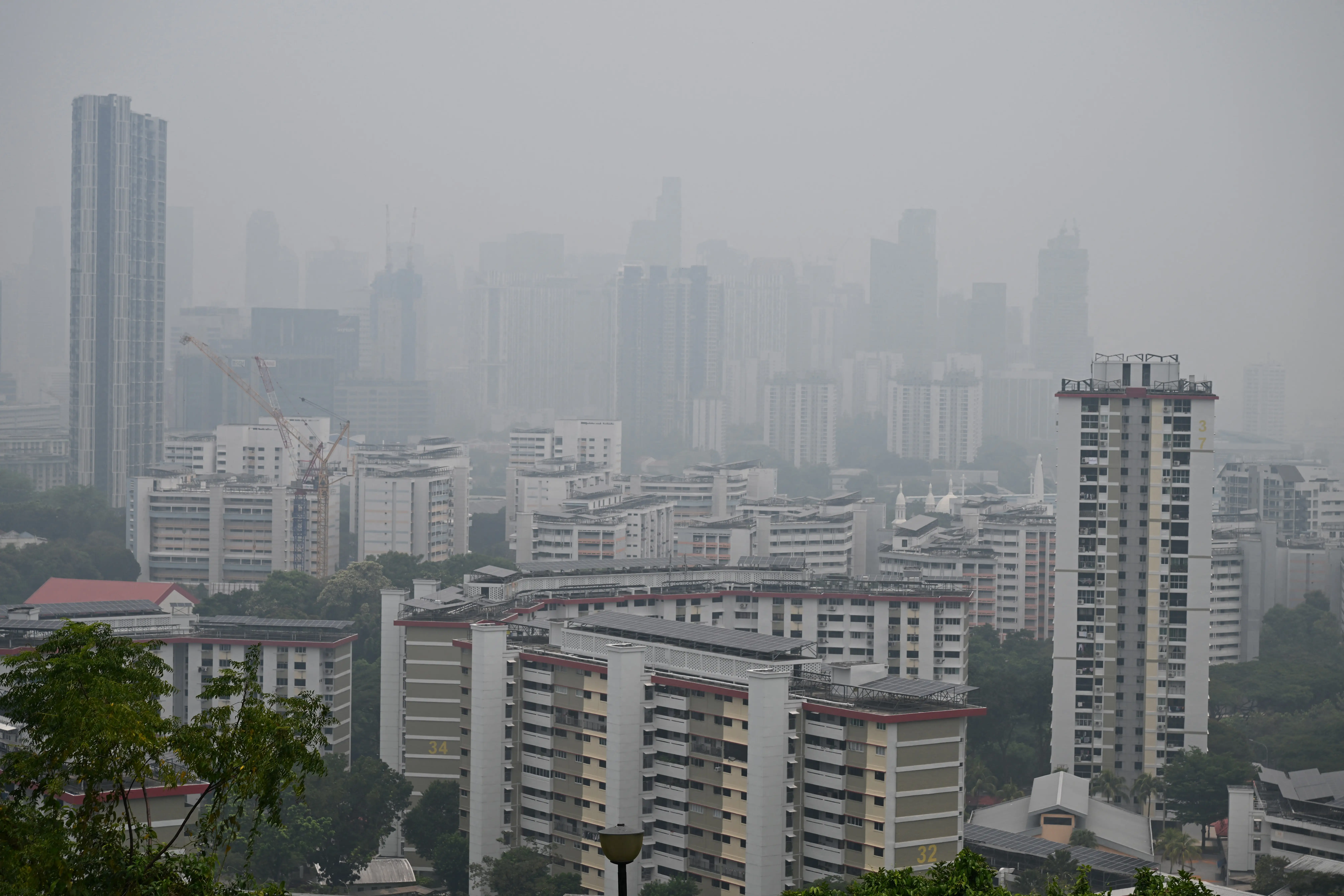 A general view shows buildings shrouded with haze in Singapore on October 9, 2026