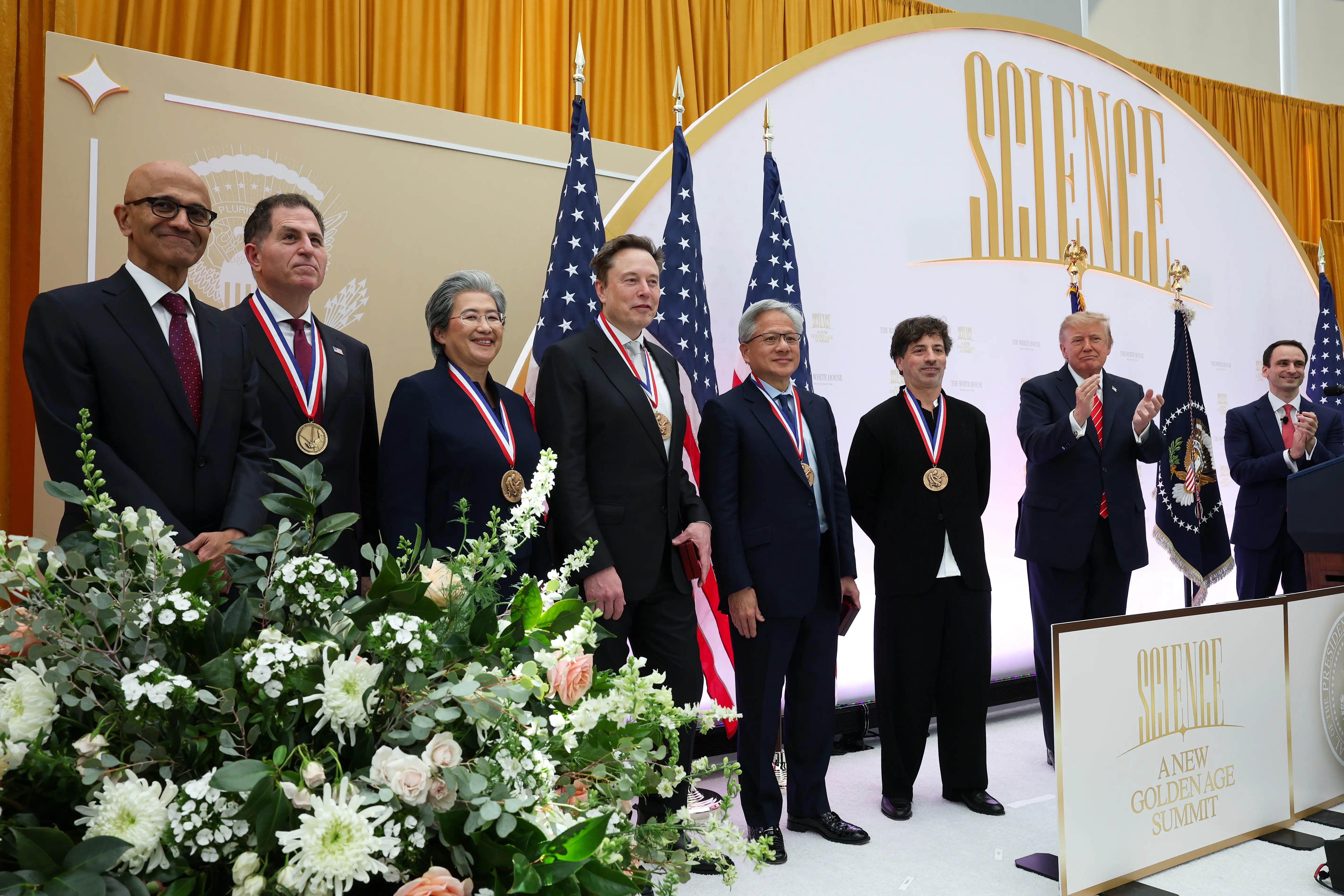 U.S. President Donald Trump (2nd-R) applauds as (L-R) CEO of Microsoft Satya Nadella, CEO of Dell Technologies Michael Dell, President and CEO of Advanced Micro Devices Lisa Su, Tesla and SpaceX CEO Elon Musk, Nvidia CEO Jensen Huang and Co-founder of Google and former President of Alphabet Sergey Brin pose for photos after being awarded National medals during the Golden Age of American Innovation Summit at the Institute of Peace on October 08, 2026 in Washington, DC.