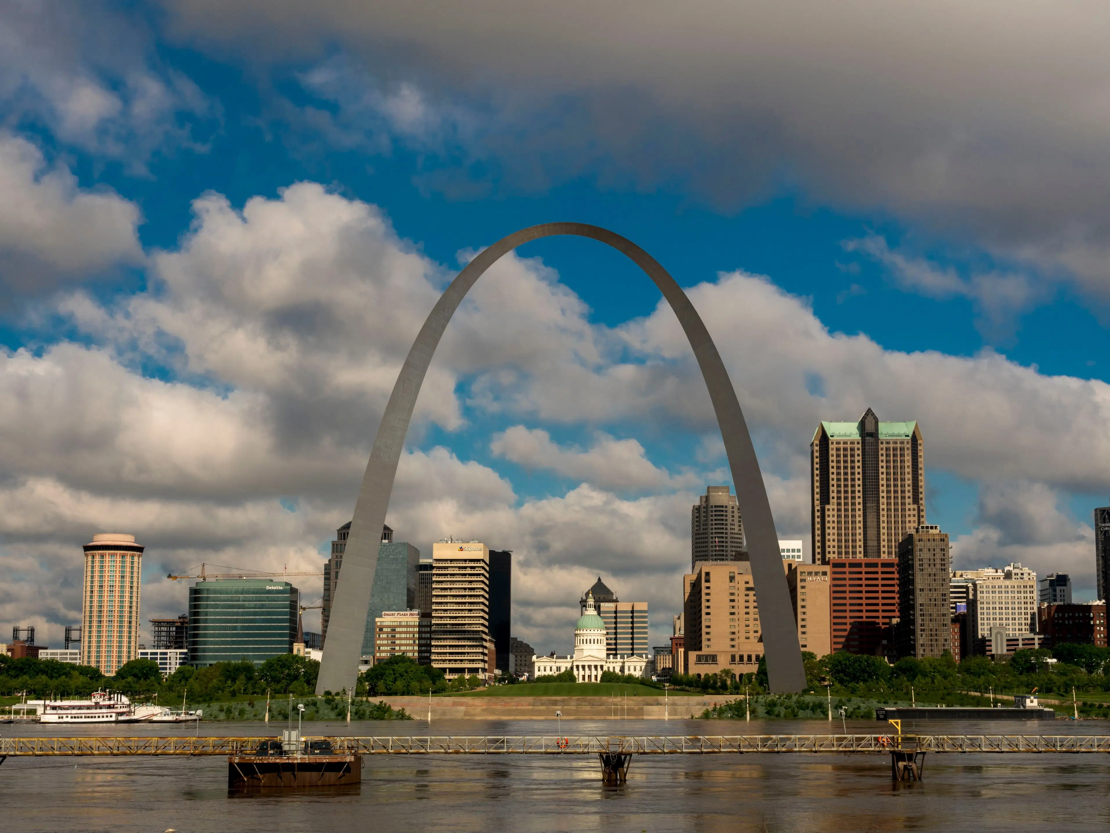 A photo of a city skyline with a river in the foreground.
