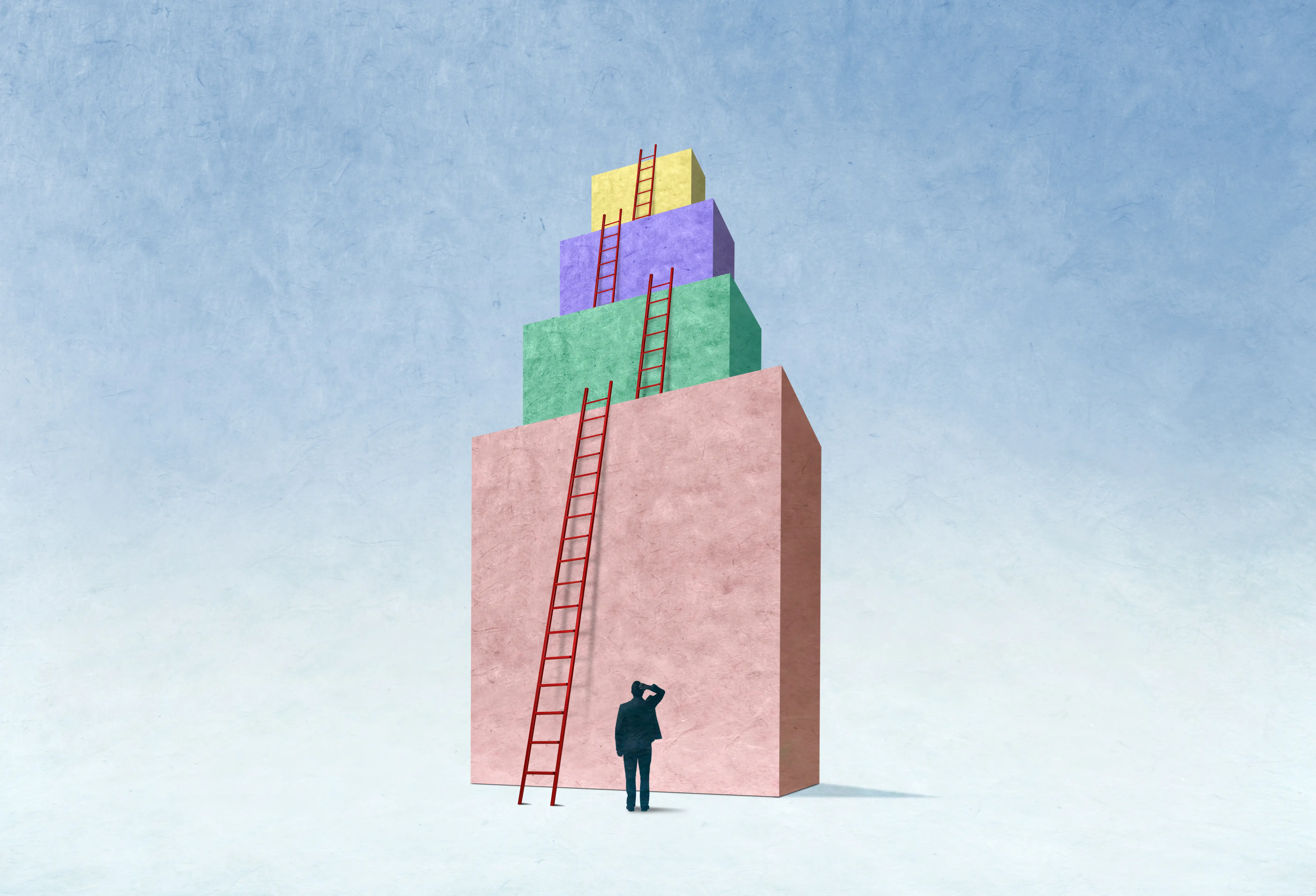 A man looks up at a series of ladders will allow him to reach the top.