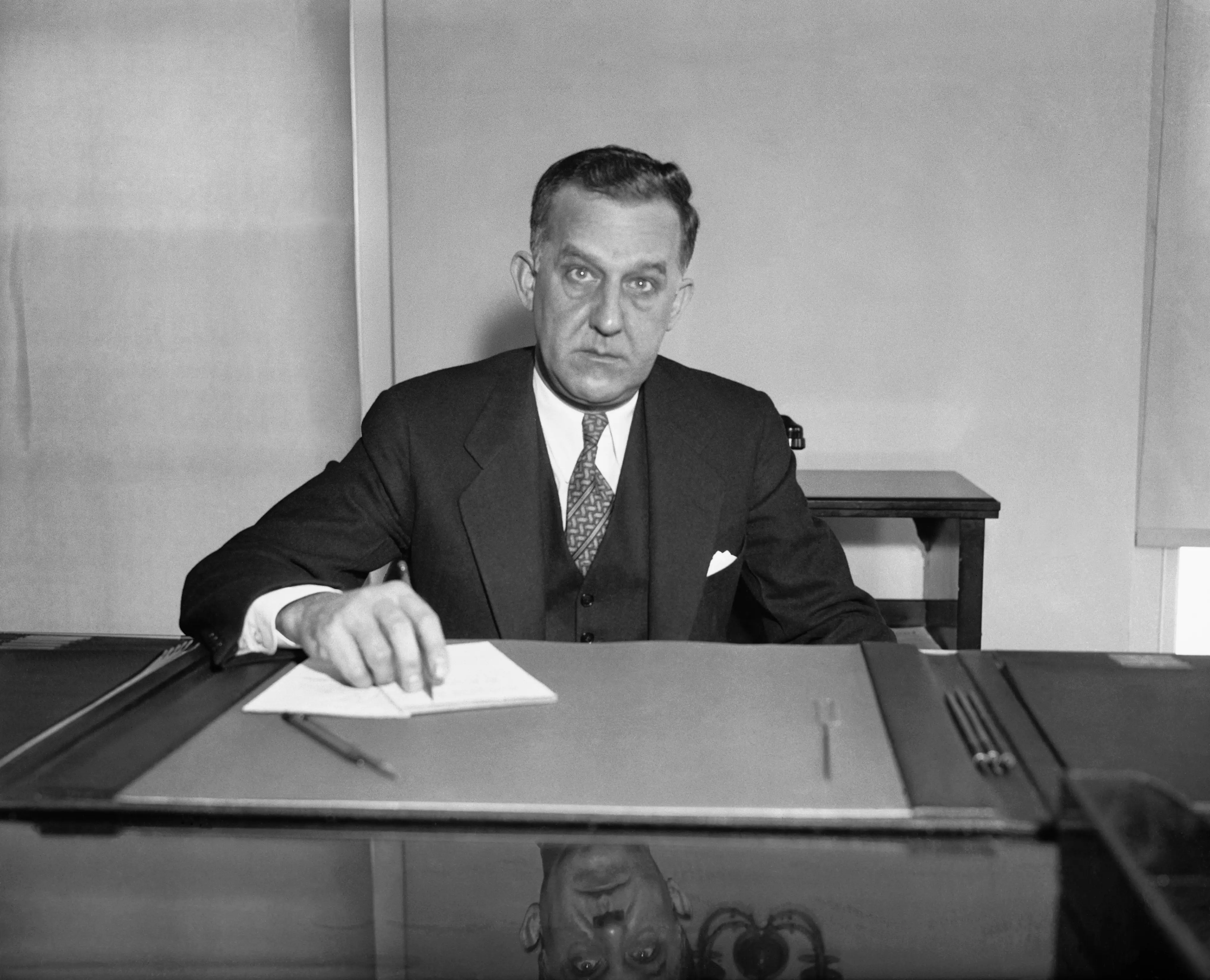A man sits at a desk.