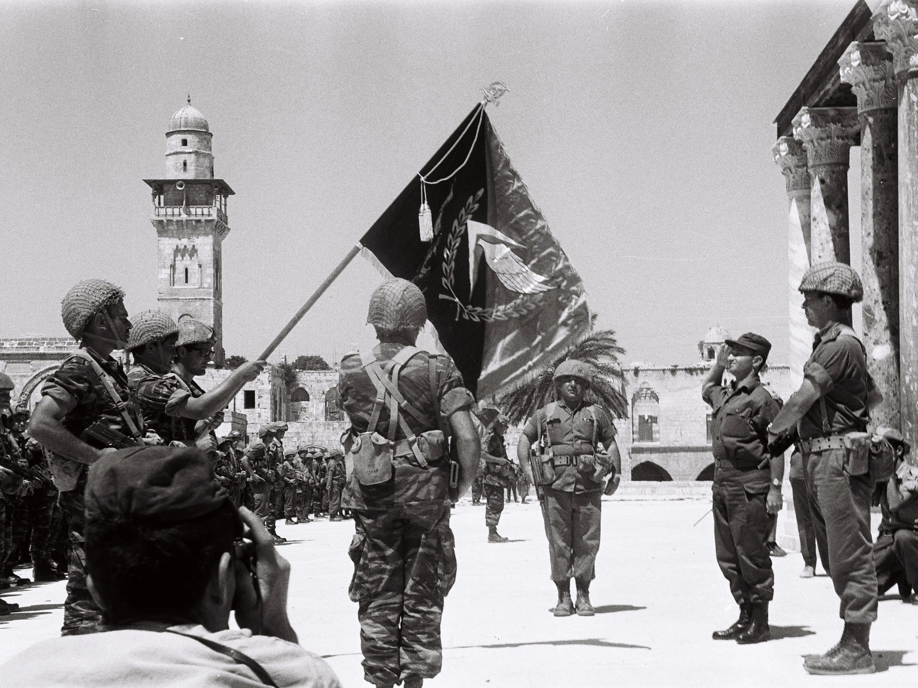 Soldiers raise a flag