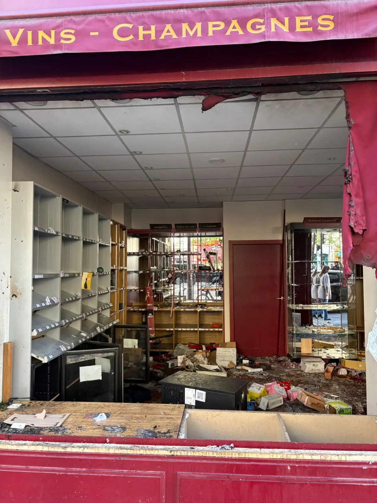 The interior of a wine store picked clean by looters.
