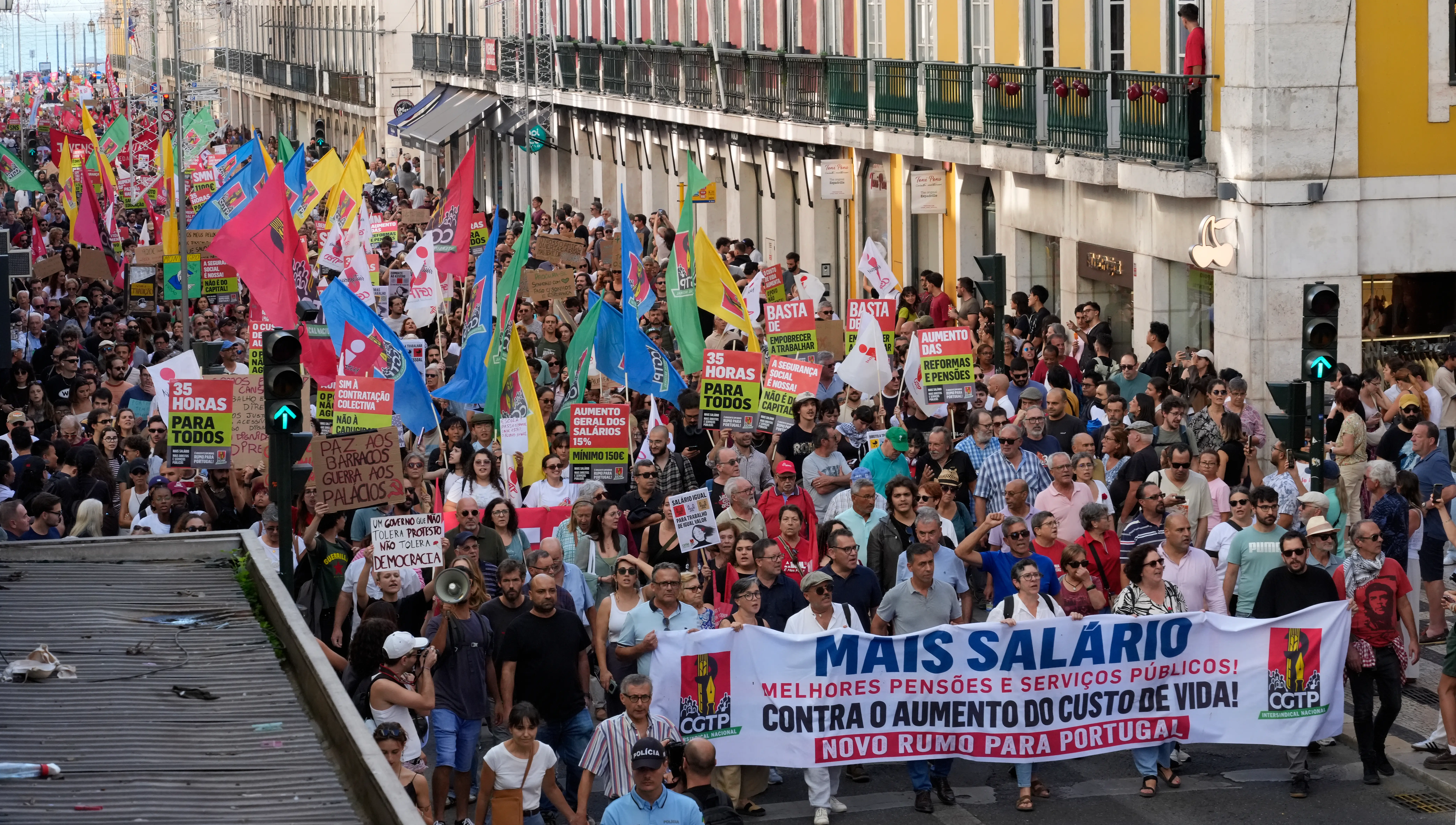 LISBON, PORTUGAL - OCTOBER 17: Participants hold signs and flags as thousands march at CGTP-IN decentralized national demonstration to demand higher wages, better pensions, and improved public services from Cais do Sodré to Rossio on October 17, 2026 in Lisbon, Portugal. The CGTP-IN demands a general increase in all wages of at least 15%, never less than 150 euros; the setting of the National Minimum Wage at 1,100 euros by 2027; the repeal of the expiration of collective bargaining agreements; the reduction of the workweek to 35 hours; the fight against precarious employment; and the strengthening of public services and the social functions of the State. CGTP-IN leader Tiago Oliveira stated that the demonstrations aim to ensure that every person who 