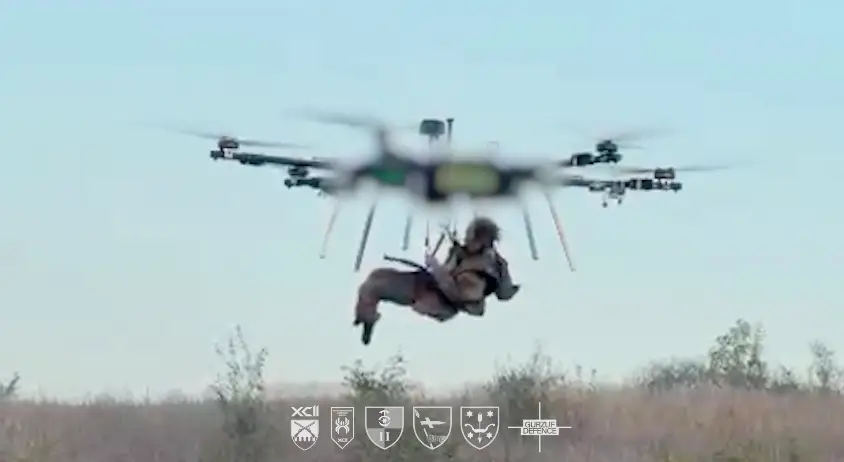 A heavy bomber drone lowers an injured Ukrainian soldier.