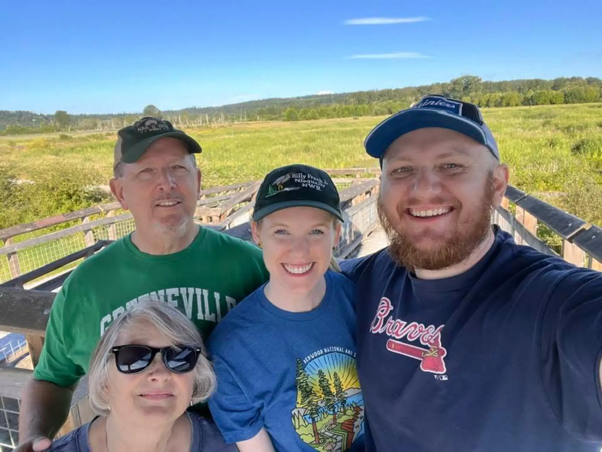Laura Grace and her husband pose for a photo with his parents.