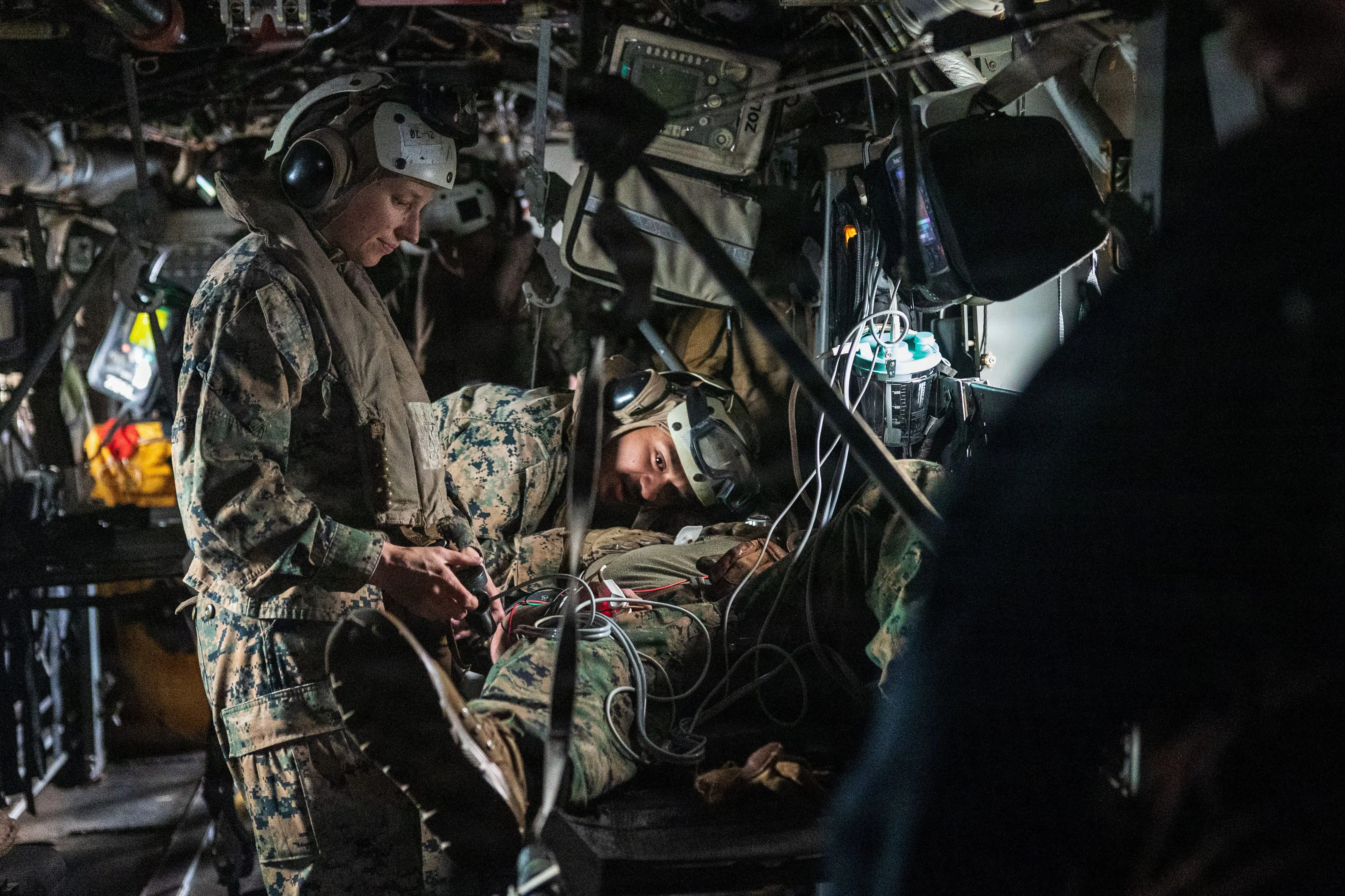 Navy corpsmen check the airway of a simulated casualty.