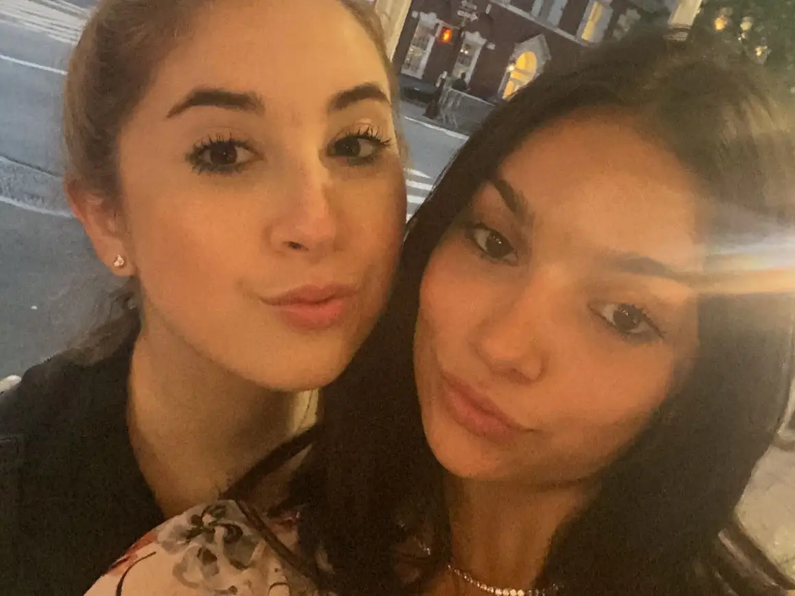 The writer is posing for a selfie with one of her friends.