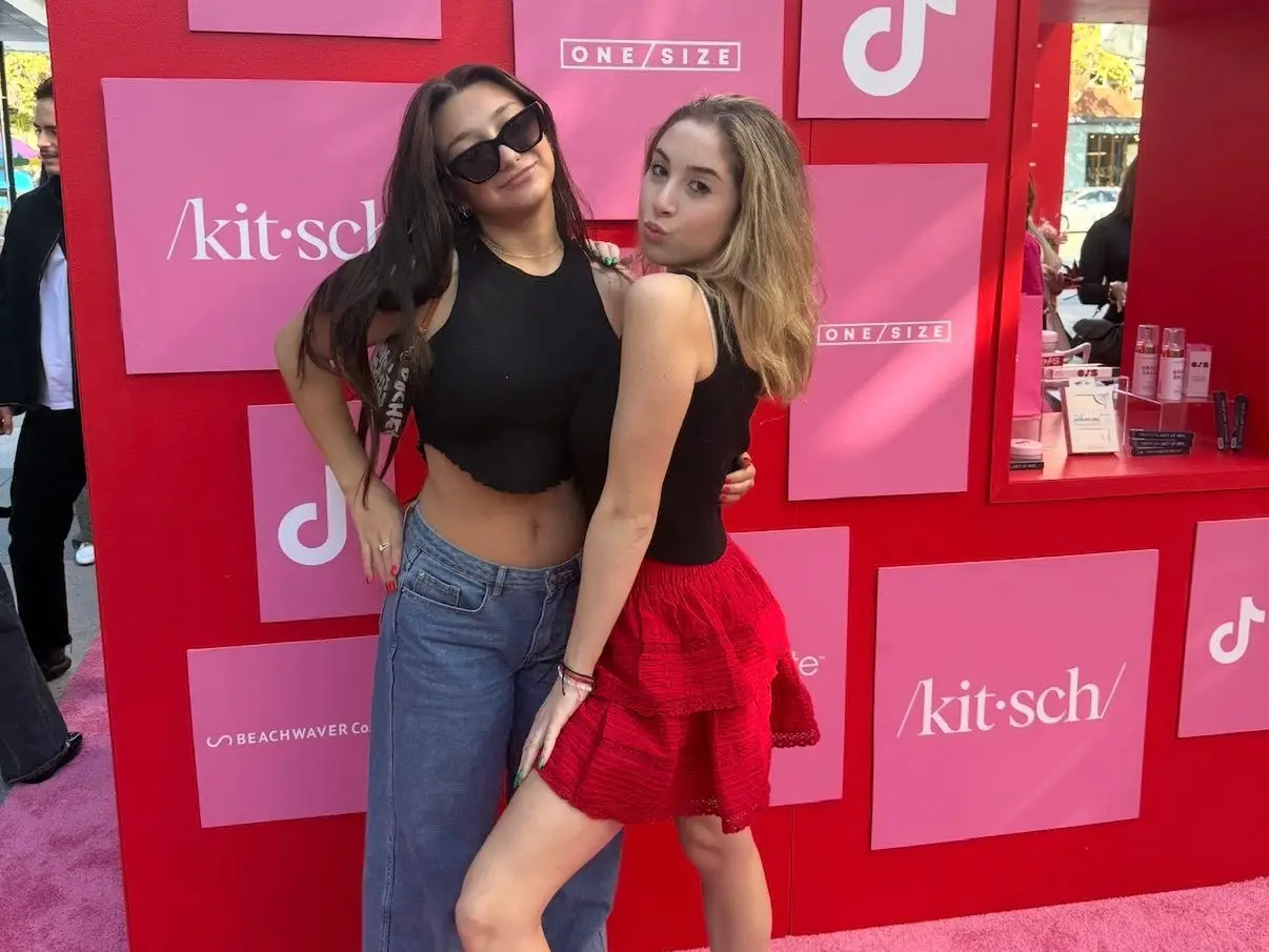 The writer and her friend are posing at an event.