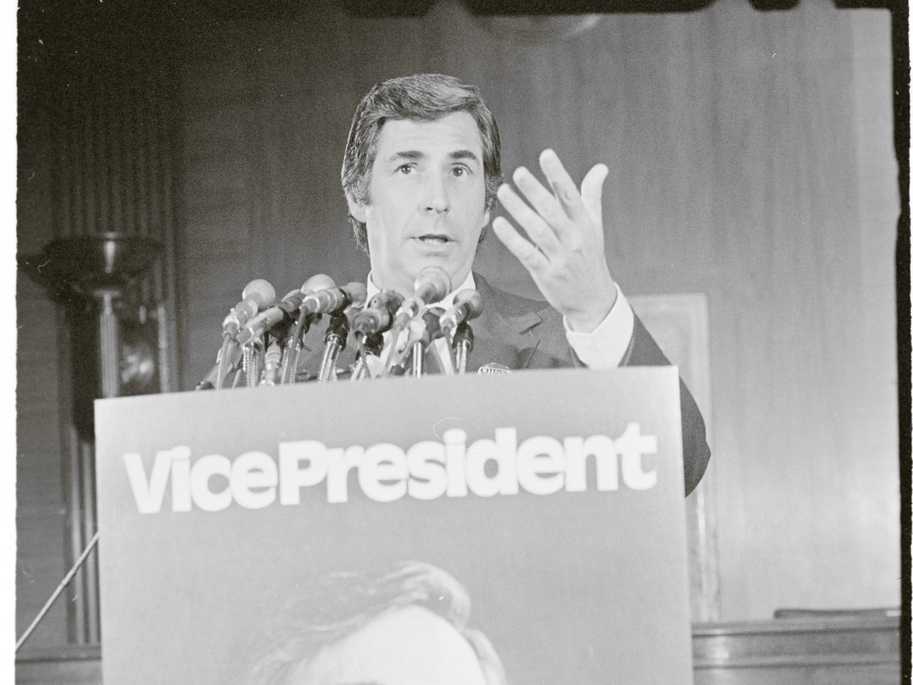 A man in a suit speaks.