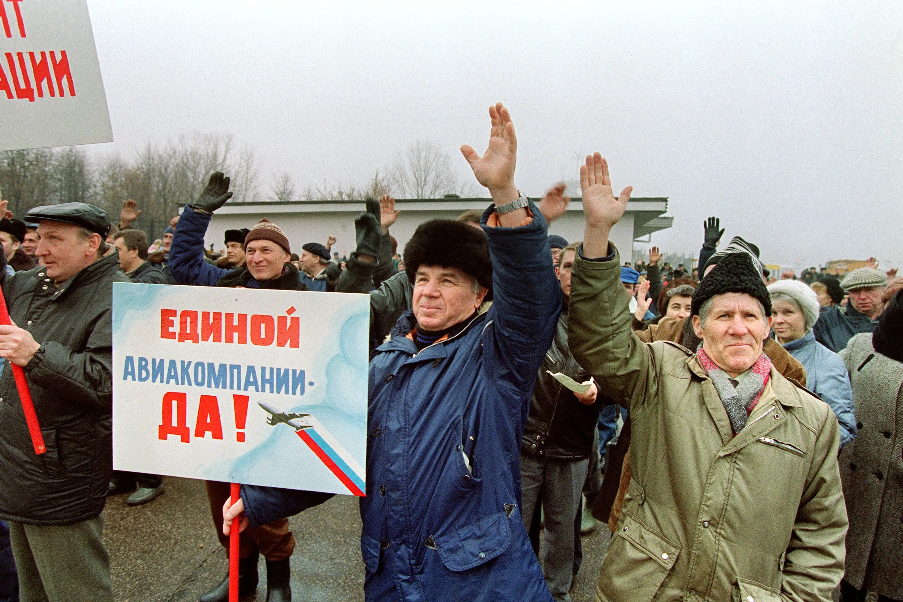 People raise their hands during a protest.