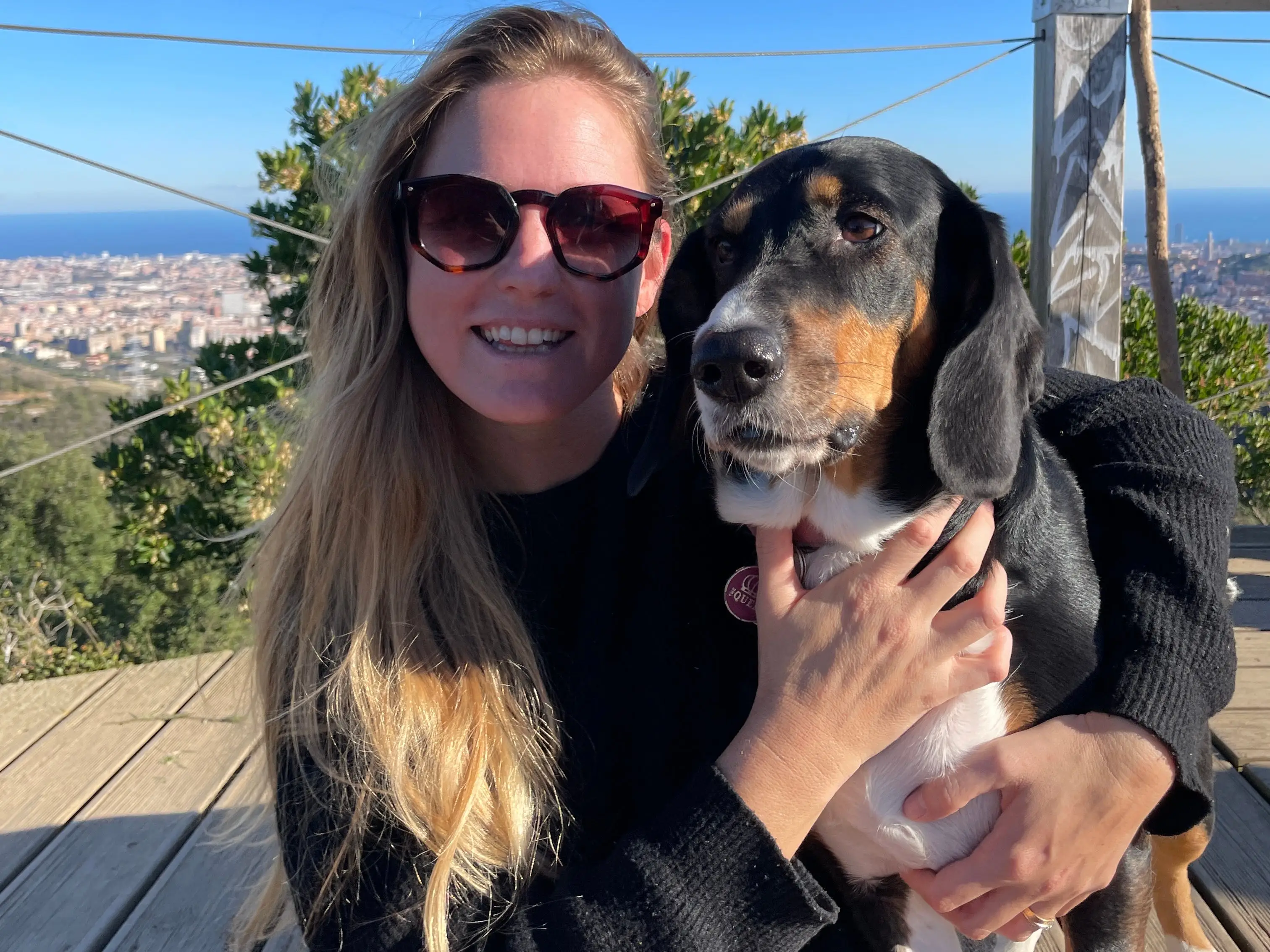 Woman smiling with dog in park