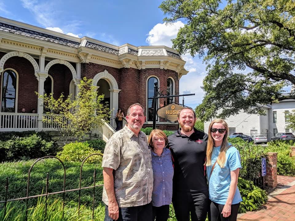 Laura Grace and her husband pose for a photo with his parents.