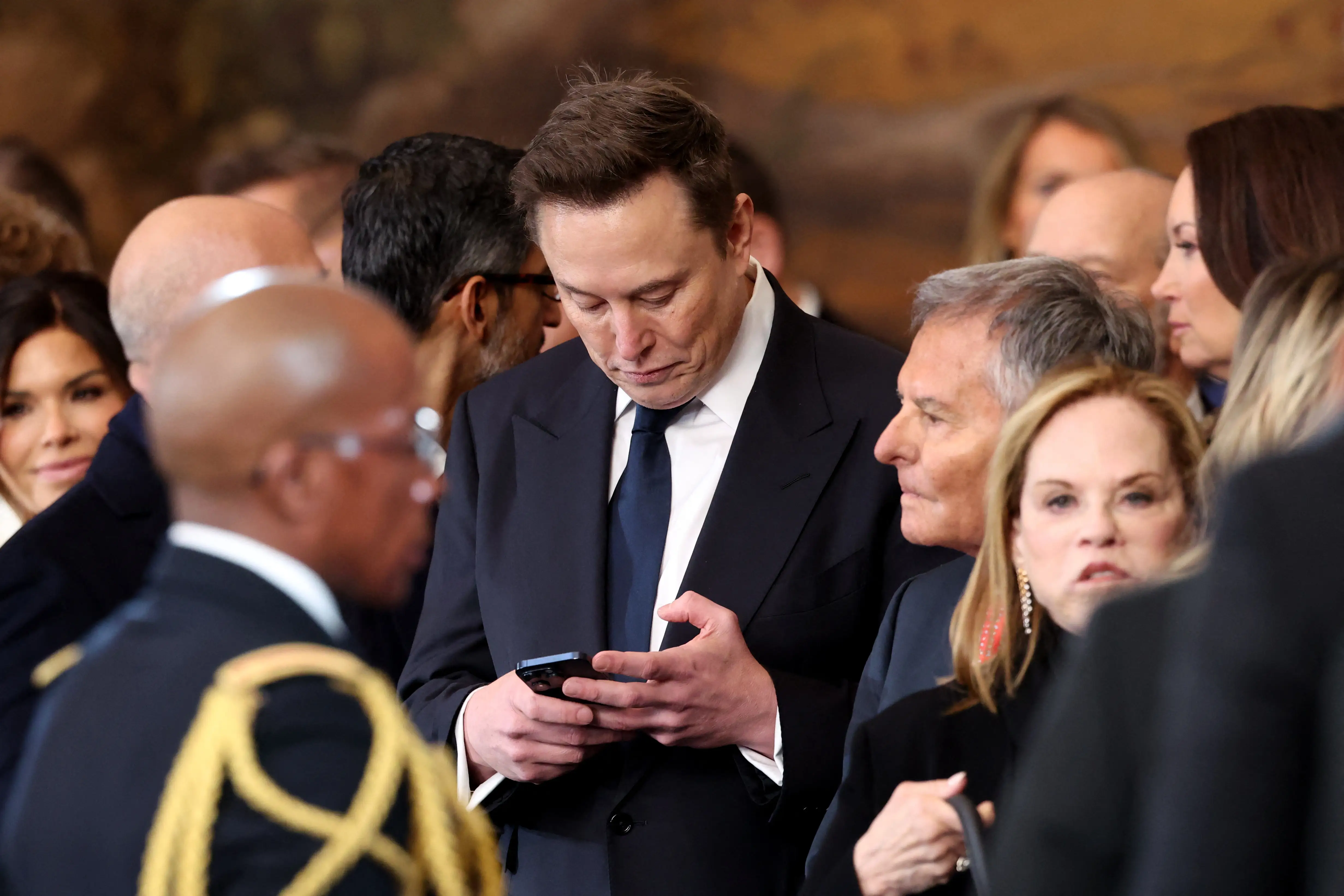 SpaceX and Tesla CEO Elon Musk looks at his phone during the inauguration of Donald Trump as the 47th president of the United States in the Rotunda of the US Capitol in Washington, DC, on January 20, 2025.
