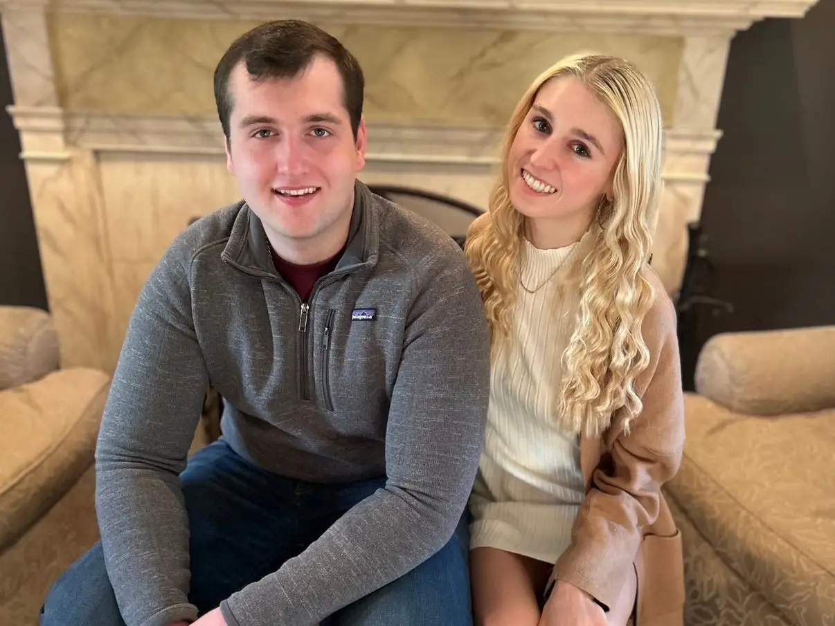 The writer is posing for a photo with her older brother.