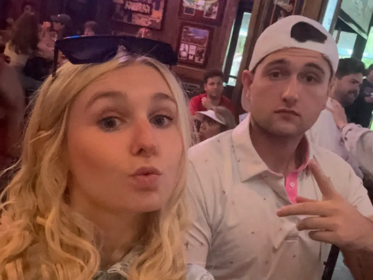 The writer is posing for a selfie with her older brother.