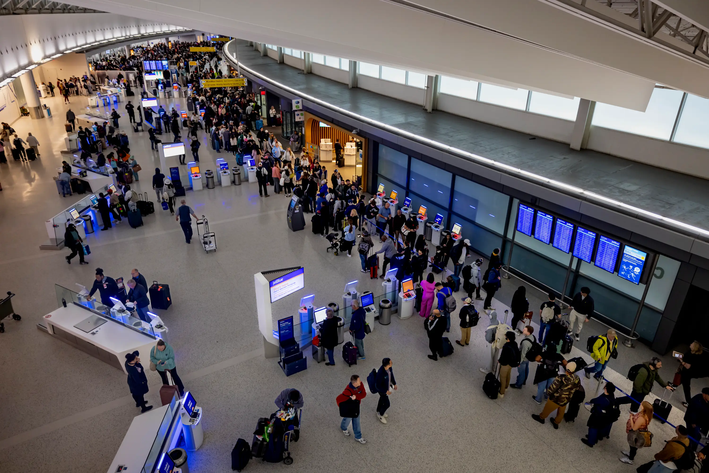 People wait in long TSA (Transportation Security Administration) security lines at John F. Kennedy International Airport
