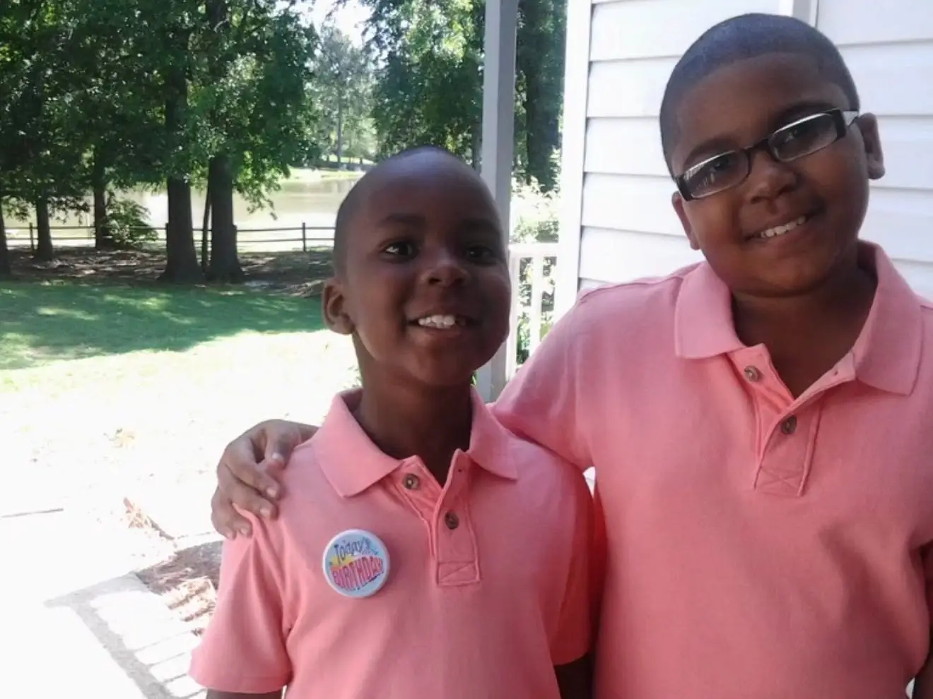The author standing beside his brother for a family photo.