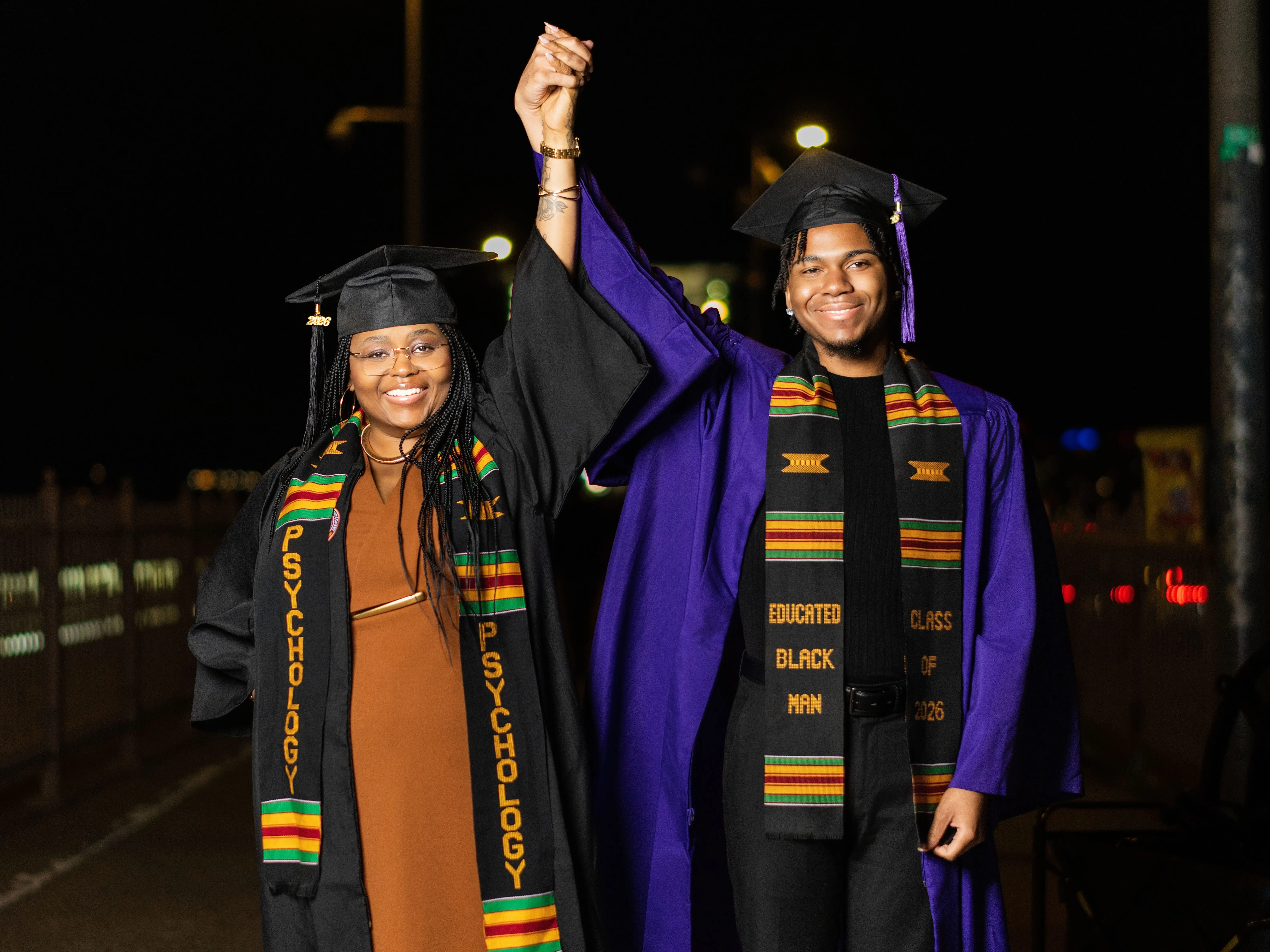 The author and his mother holding hands during their graduation celebration.