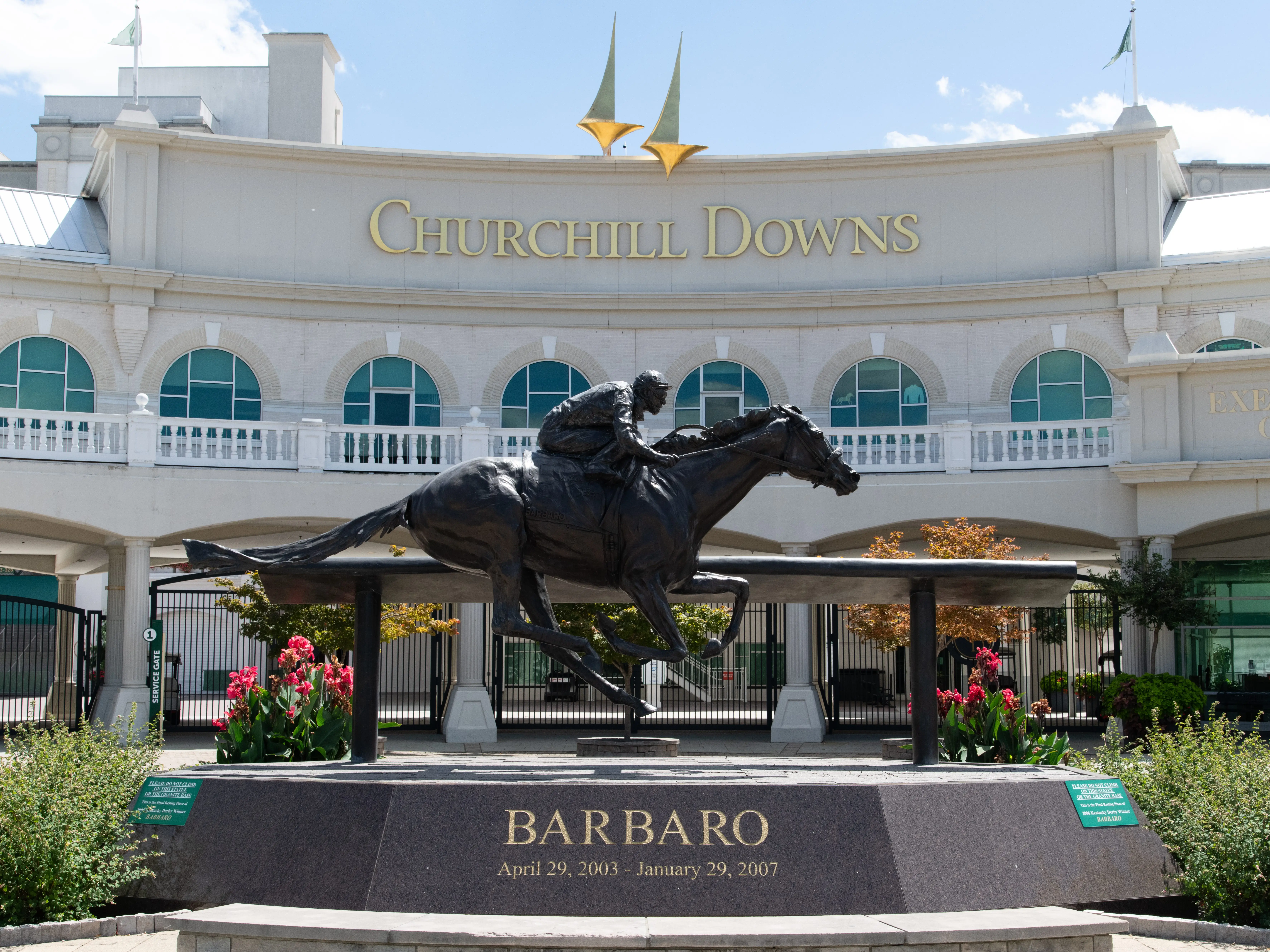 Horizontal photo of the Grand Entrance to the Kentucky Derby at Churchill Downs in Louisville Kentucky. Shown is a sculpture of the thoroughbred, Barbaro.