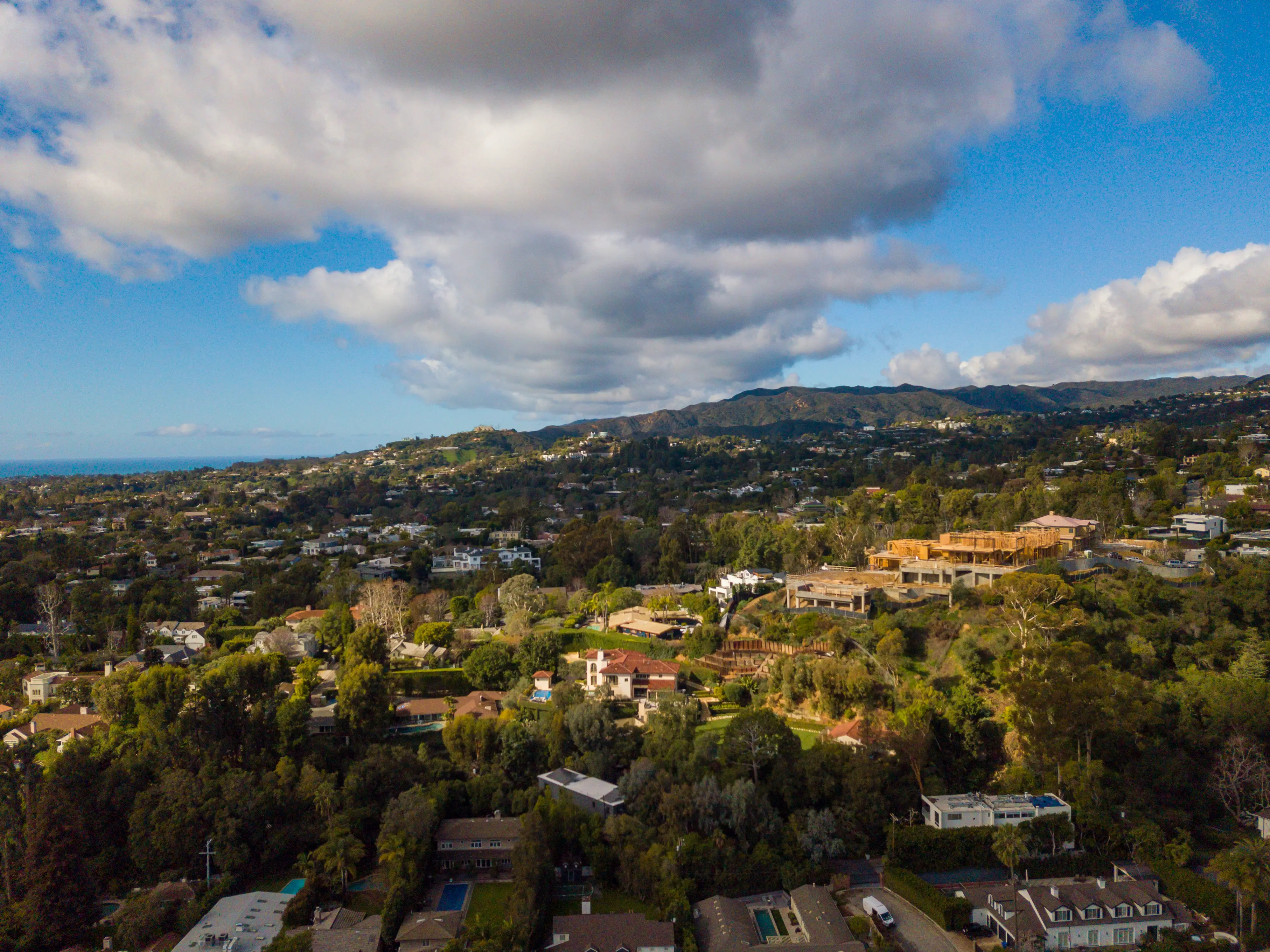 Aerial views of a large under-construction mansion that is sitting on a hill in the Brentwood neighborhood.